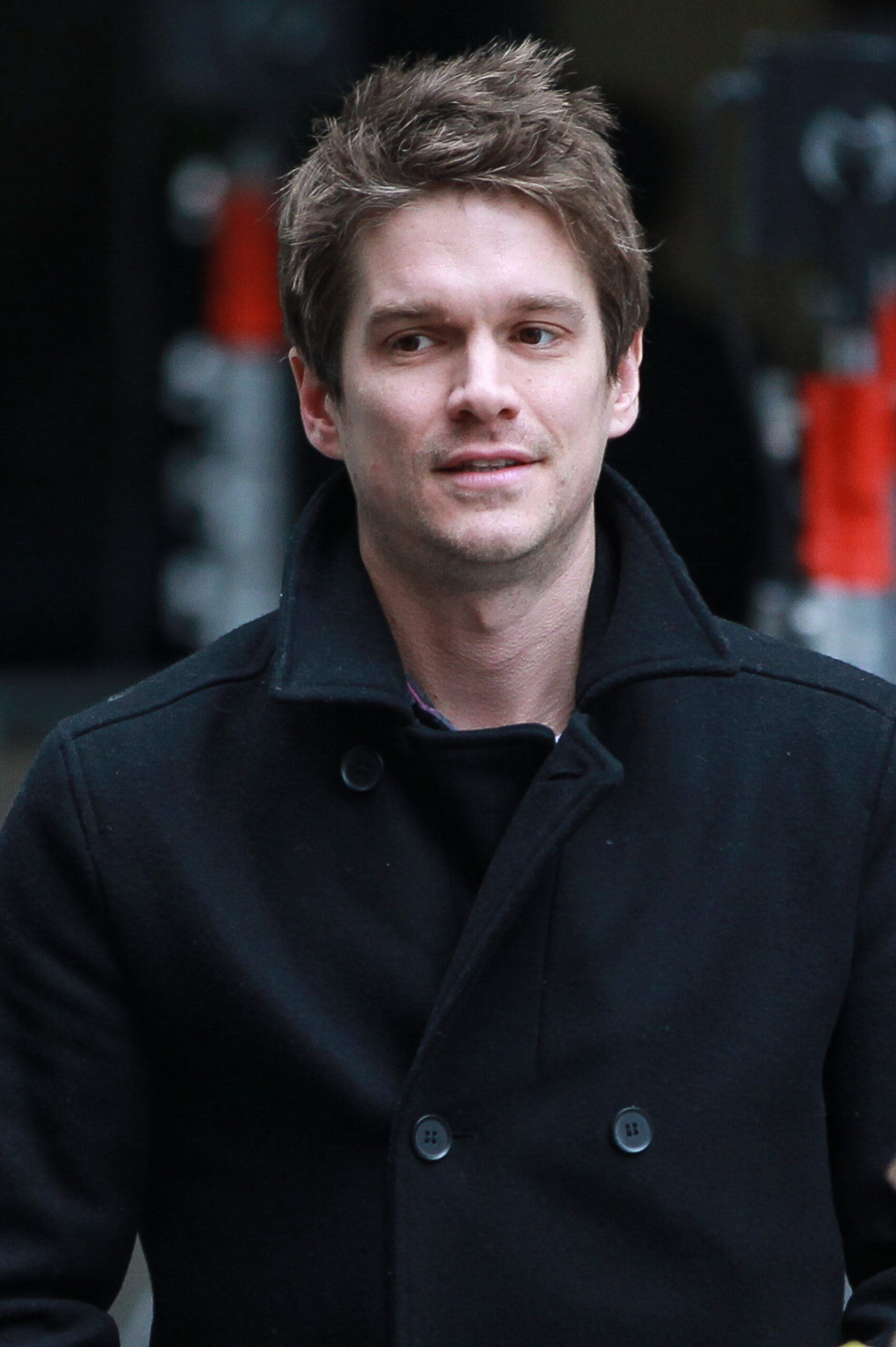 Jesse Wood wears a black coat