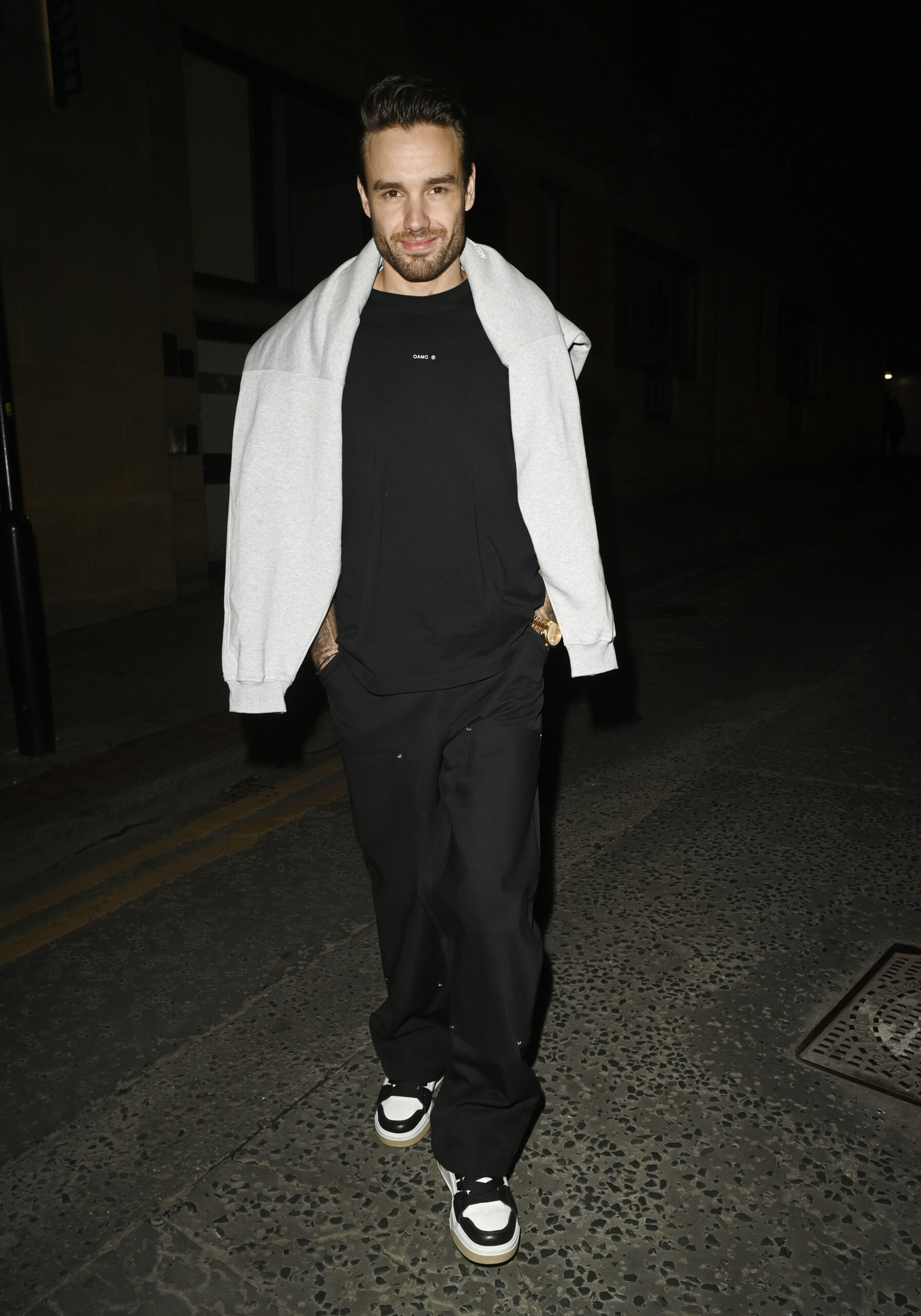 Liam Payne walking to his Manchester hotel with his hands in his pockets 
