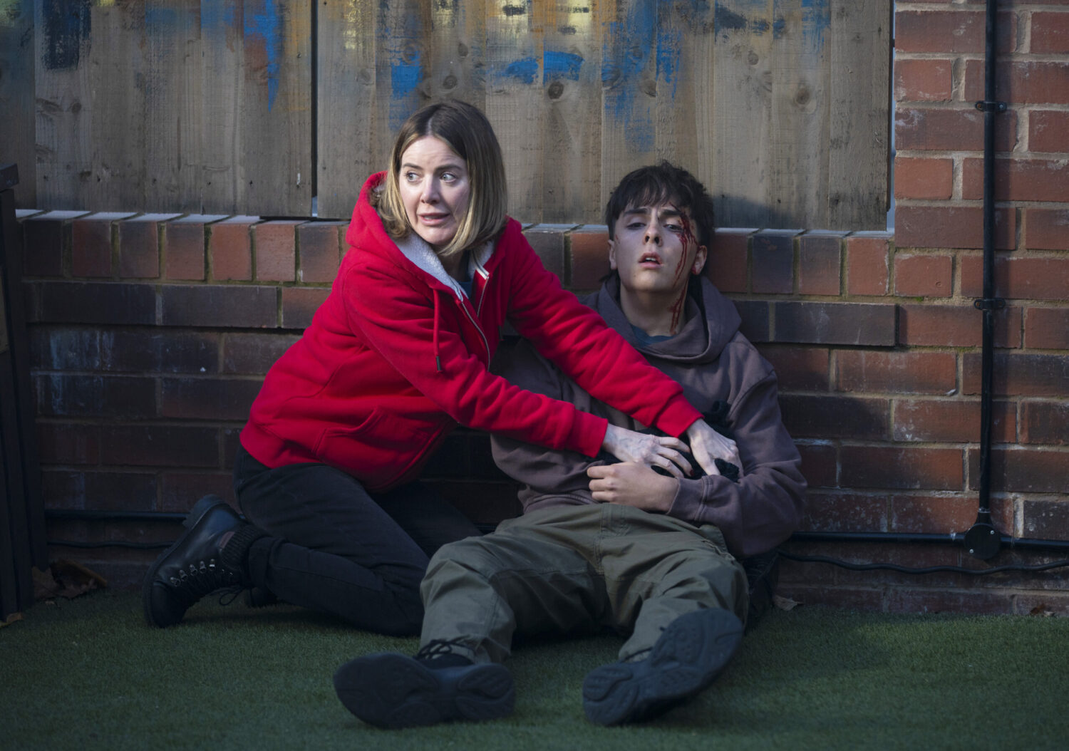 Coronation Street's Abi holding onto a wounded, bleeding Mason