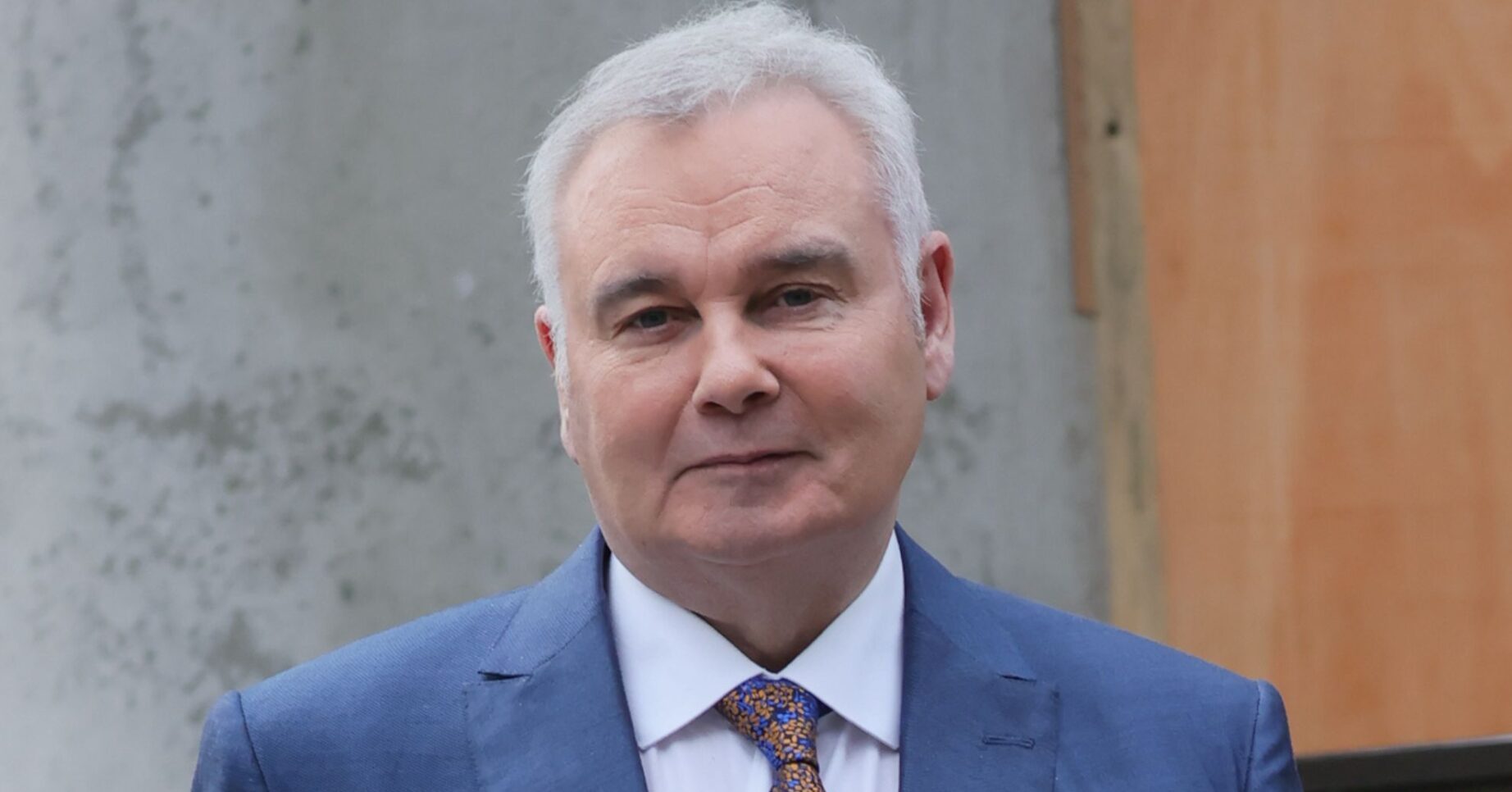 Eamonn Holmes in blue suit outside TV studios