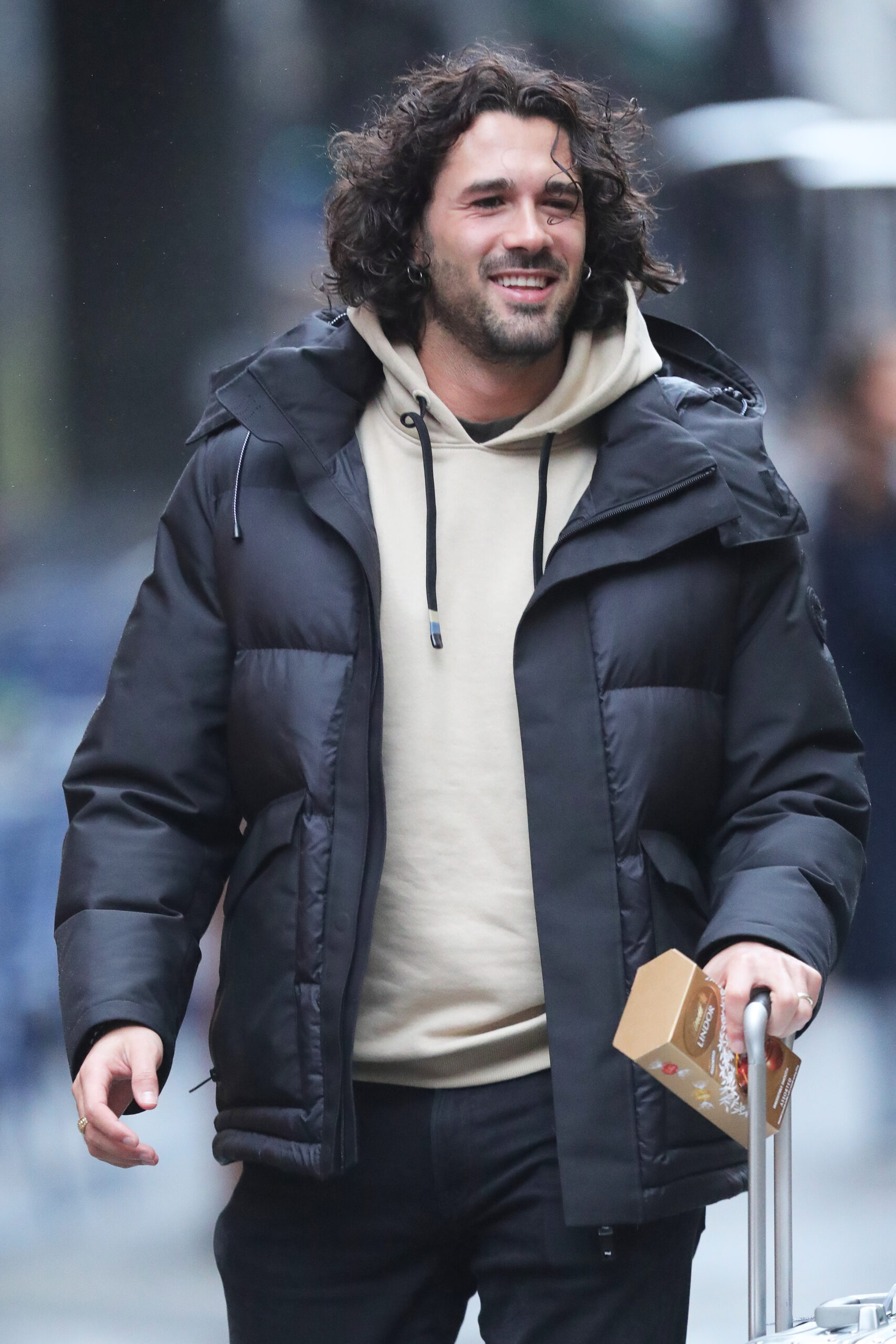 Graziano Di Prima smiling and walking in coat