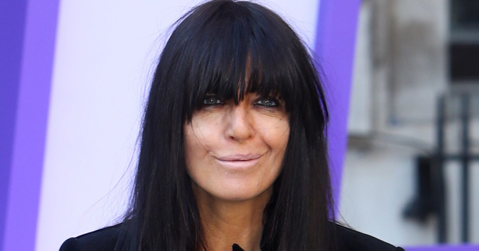 Claudia Winkleman smiles as she poses for camera