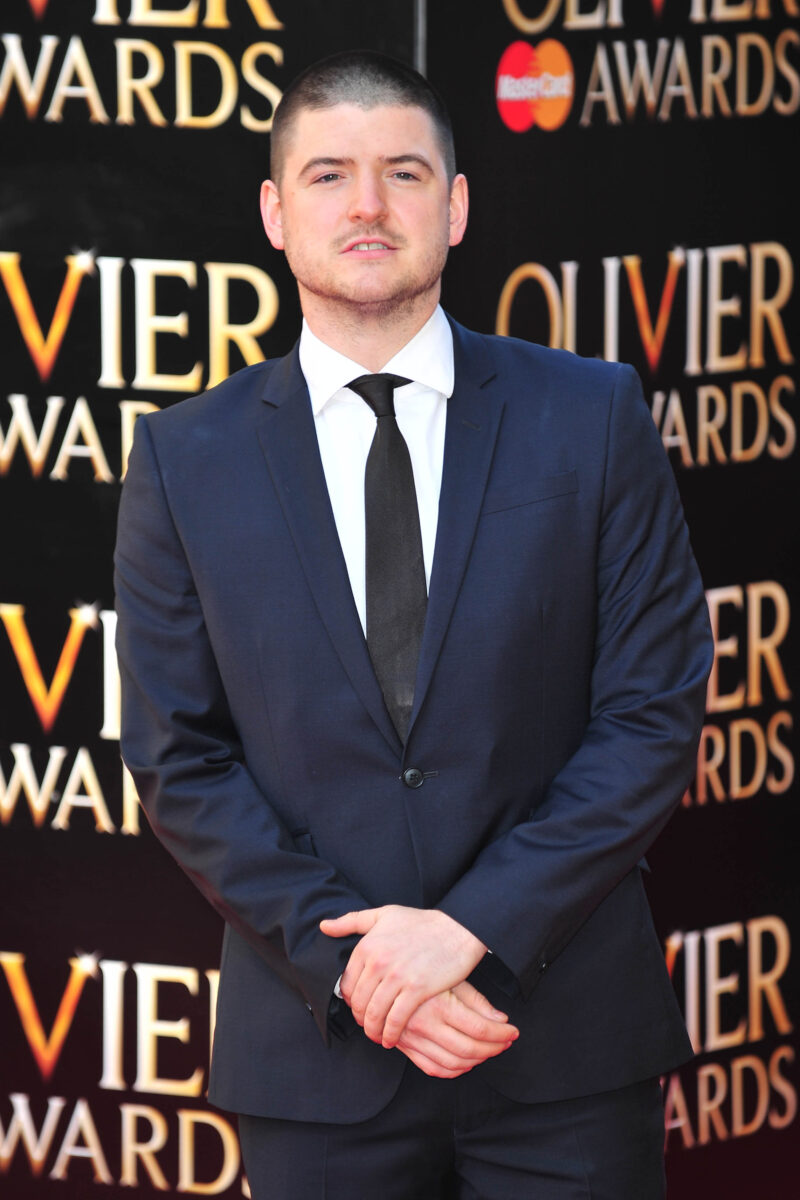 James Alexandrou in a suit posing for the cameras