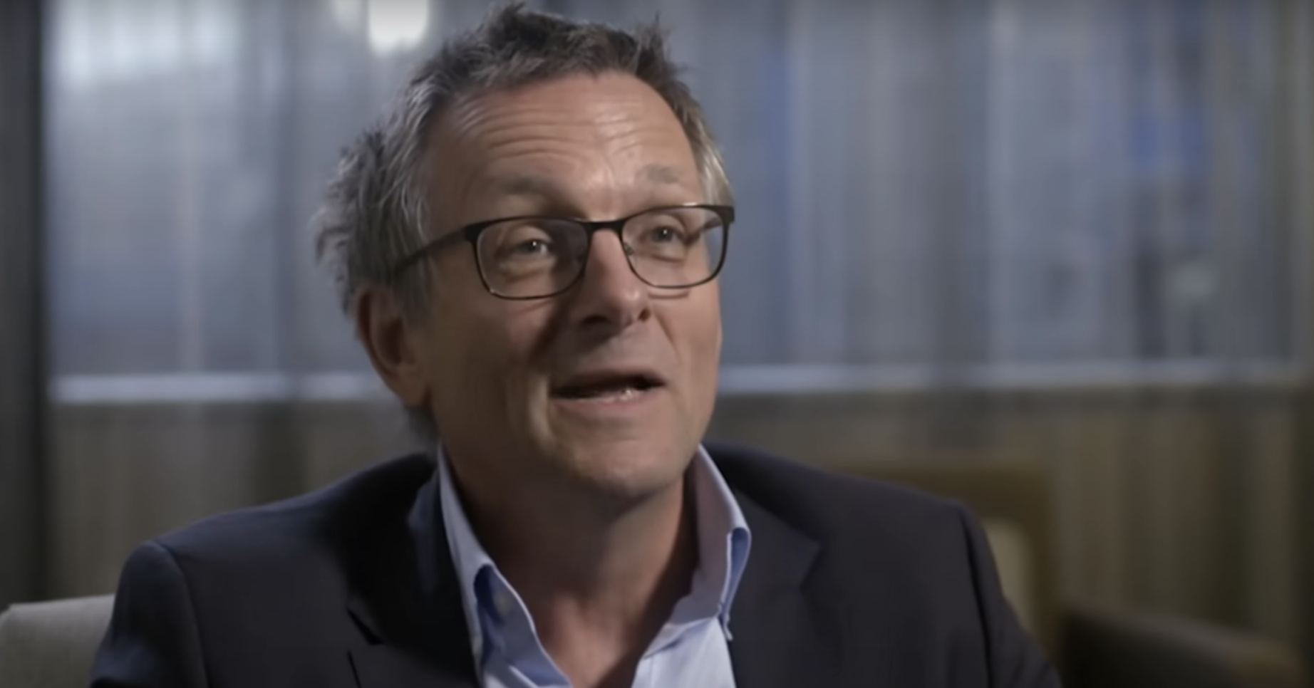 Michael Mosley in a suit during an interview for a podcast