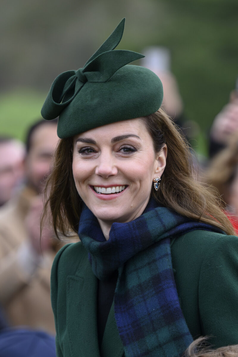 Princess Kate smiling in green outfit during Christmas Day walkabout