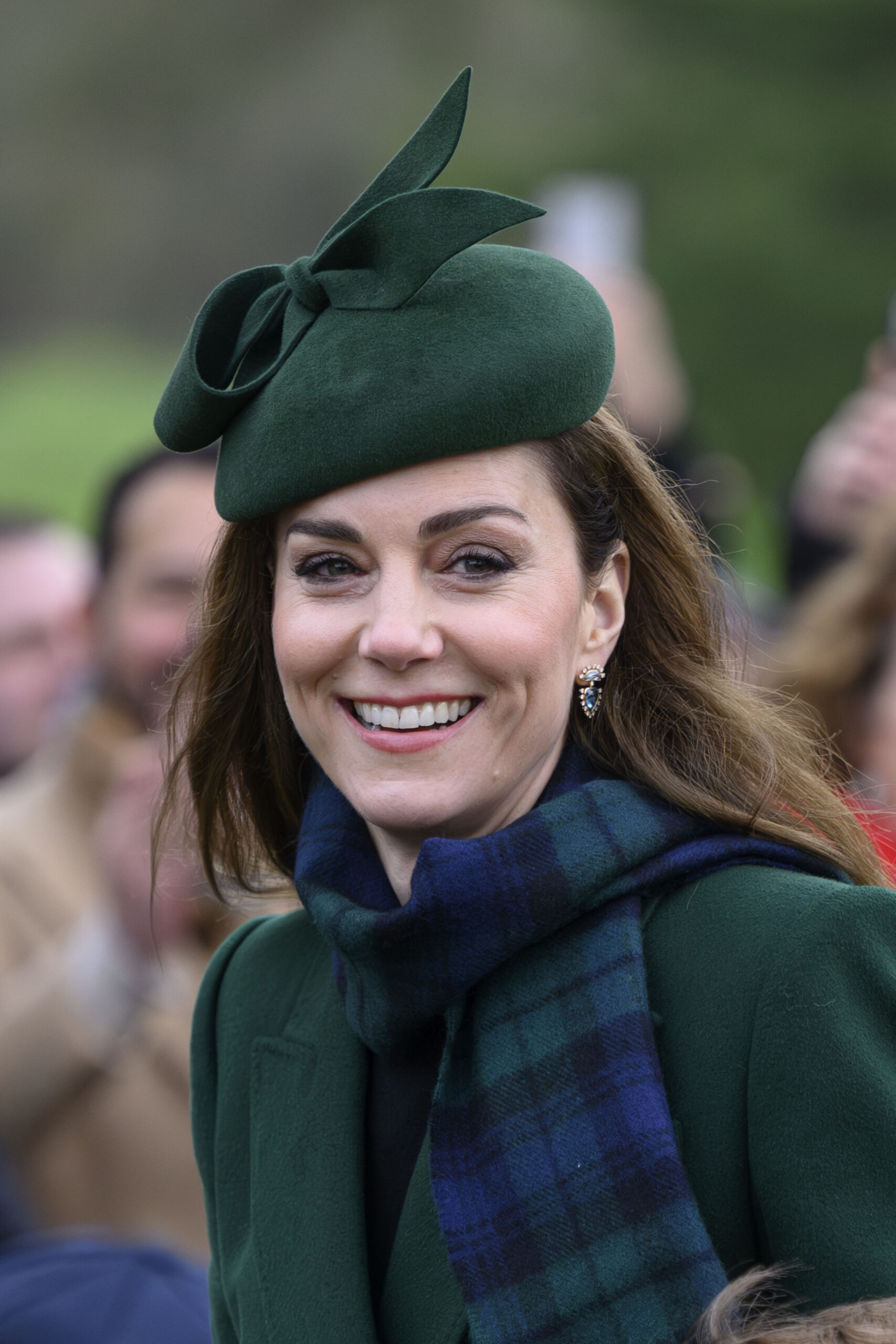 Princess Kate smiling in green outfit during Christmas Day walkabout