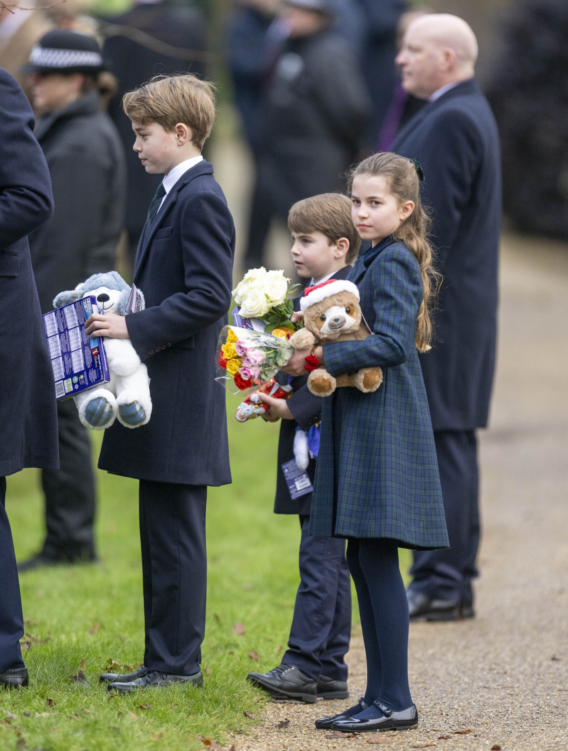 Prince George, Prince Louis and Princess Charlotte carrying gifts during Christmas Day walkabout