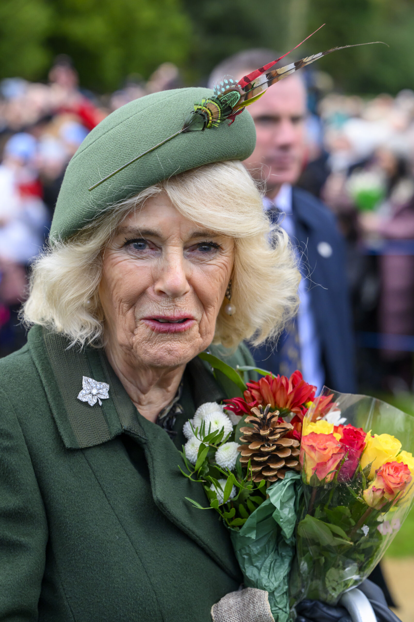 Queen Camilla smiling with flowers on Christmas Day walkabout