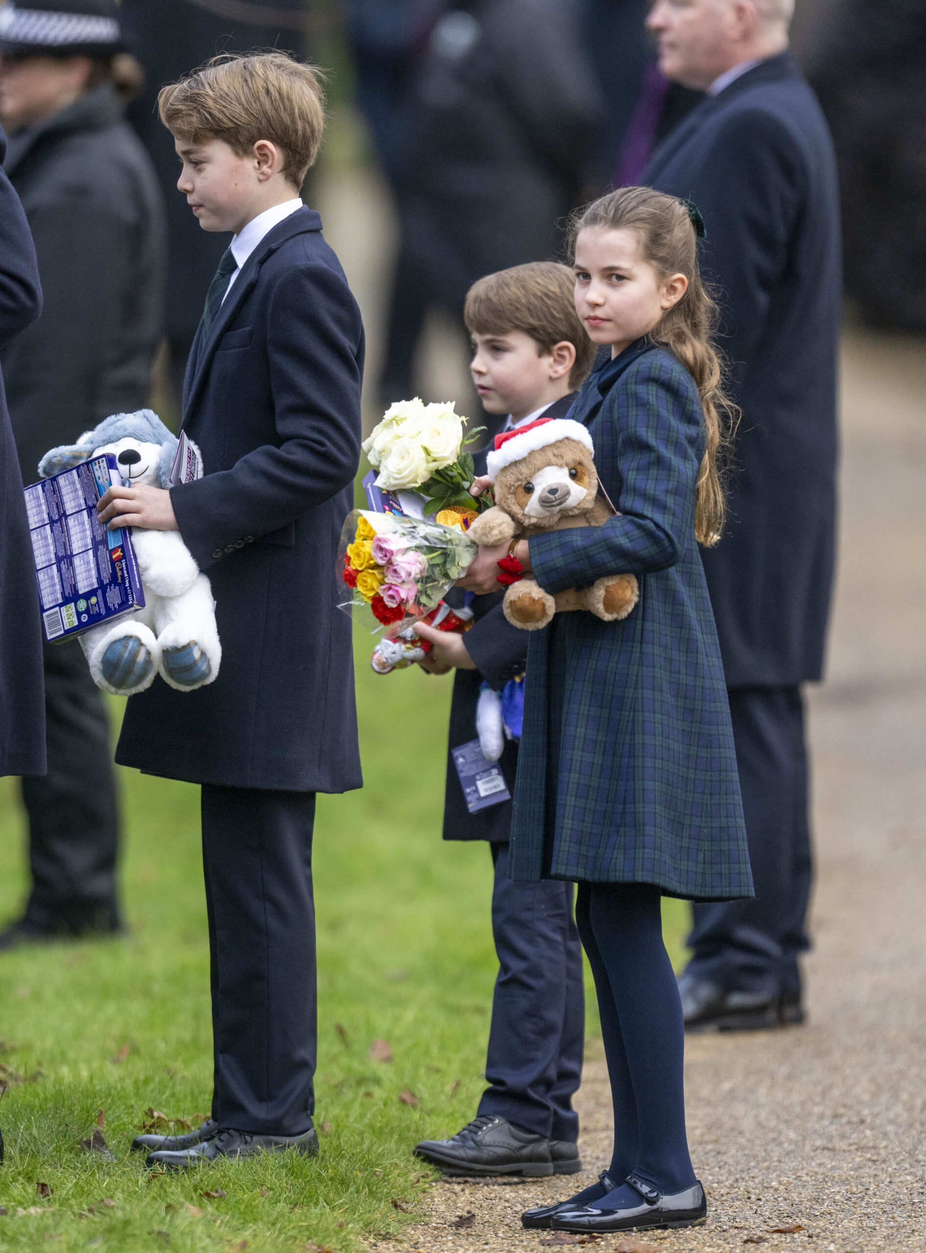 Prince George, Prince Louis and Princess Charlotte carrying gifts during Christmas Day walkabout