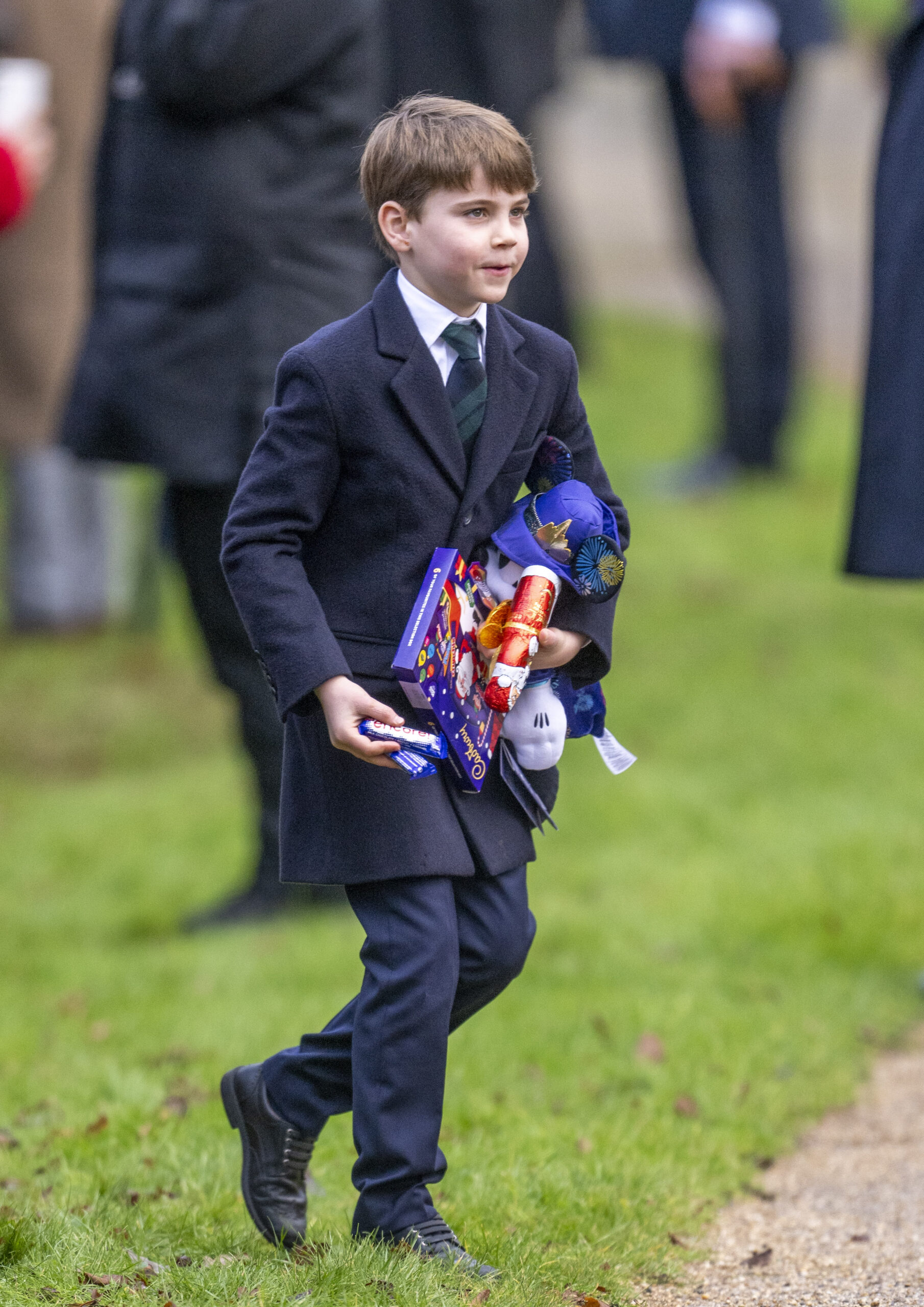 Prince Louis holding gifts during Christmas Day walkabout