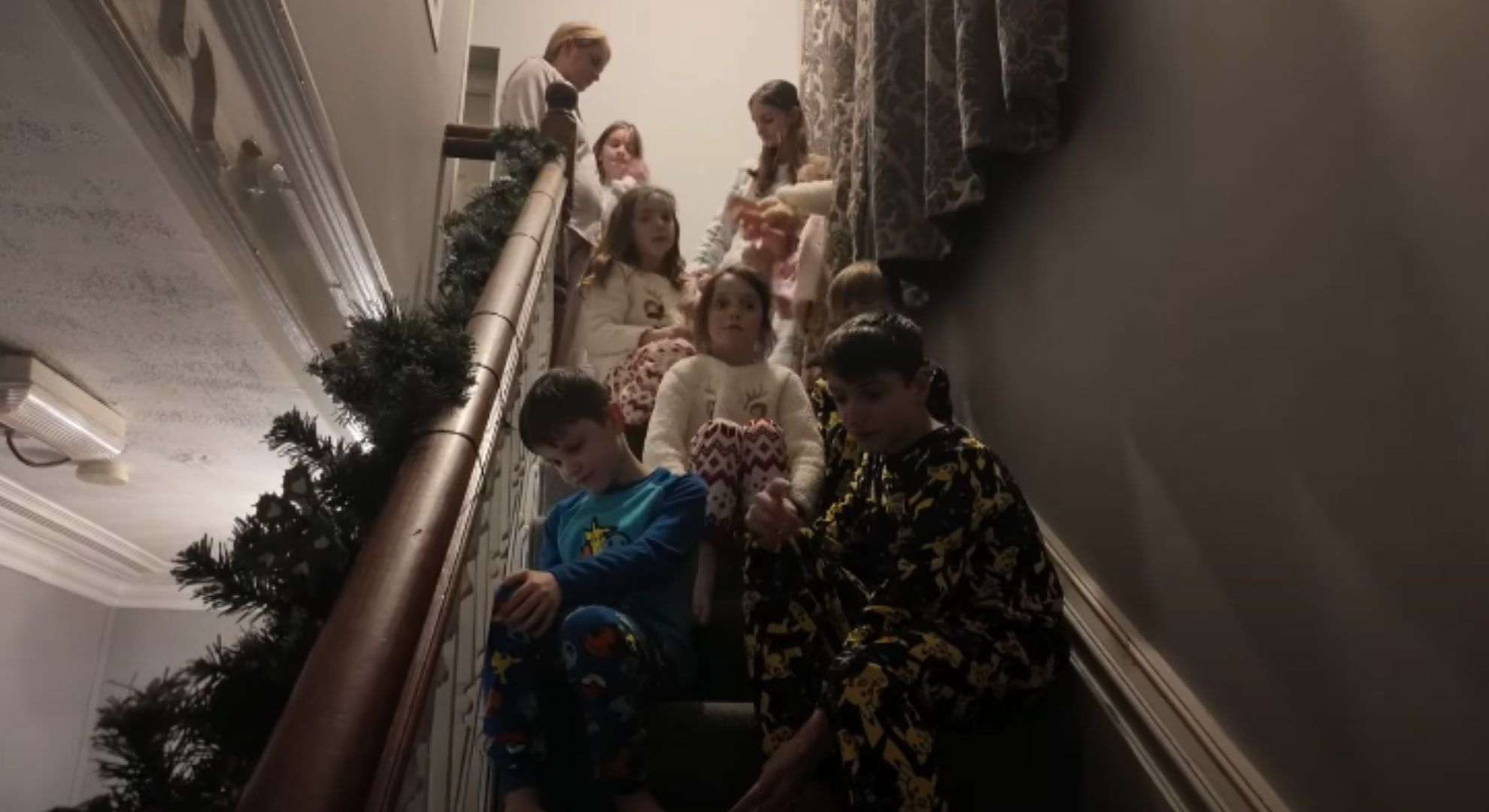 The Radford family children sat on the stairs on Christmas morning