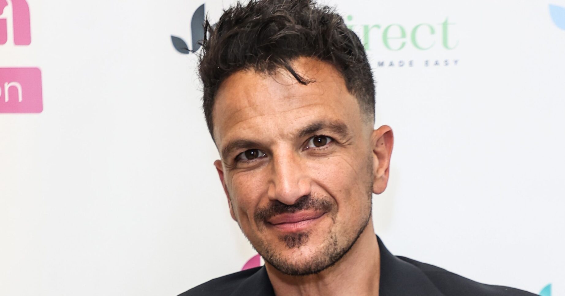 Peter Andre smiles as he poses for the camera