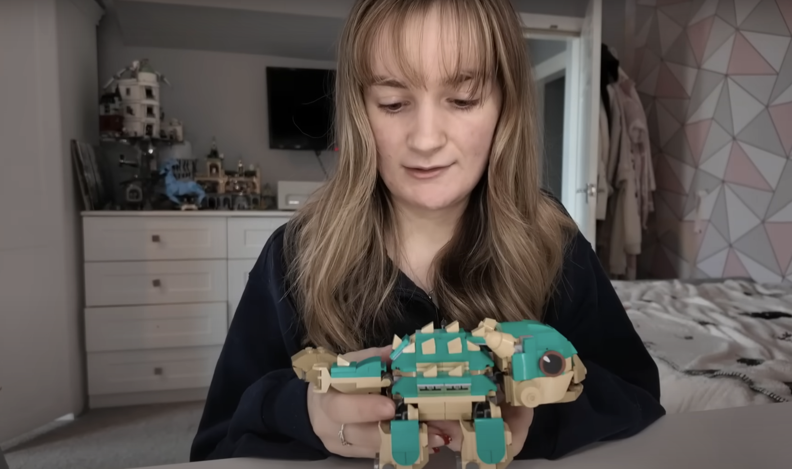 A member of the Radford family showing off a toy to the camera while recording a vlog