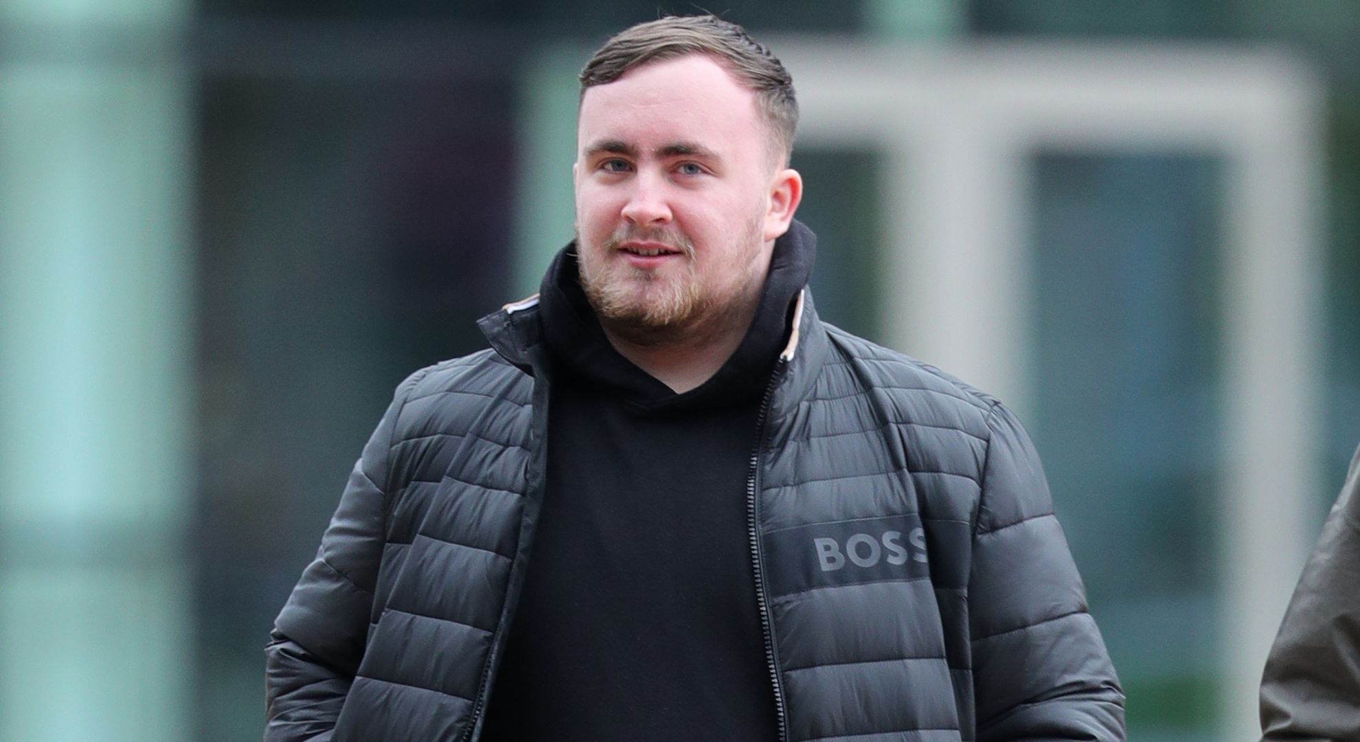 Luke Littler wearing a jacket whilst walking outside