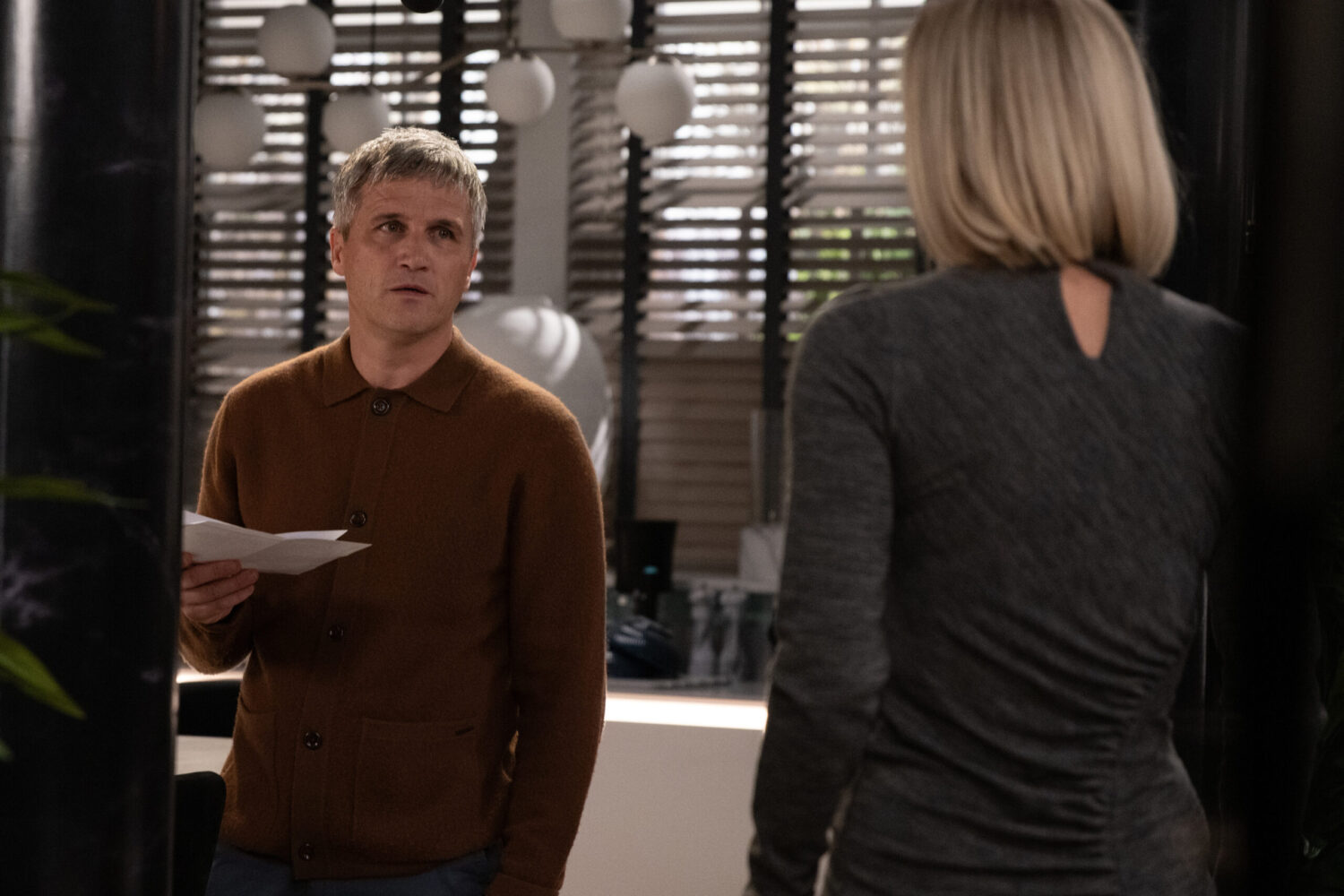 Caleb talking to Ruby whilst holding DNA results