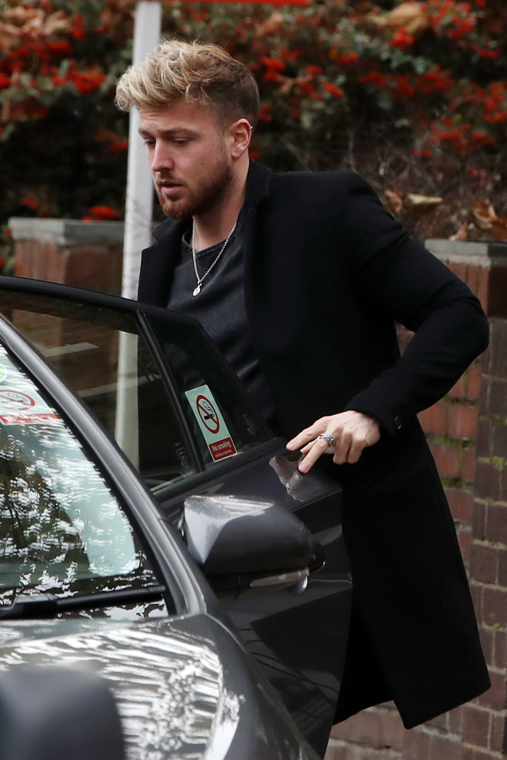 Sam Thompson looking glum getting into a car