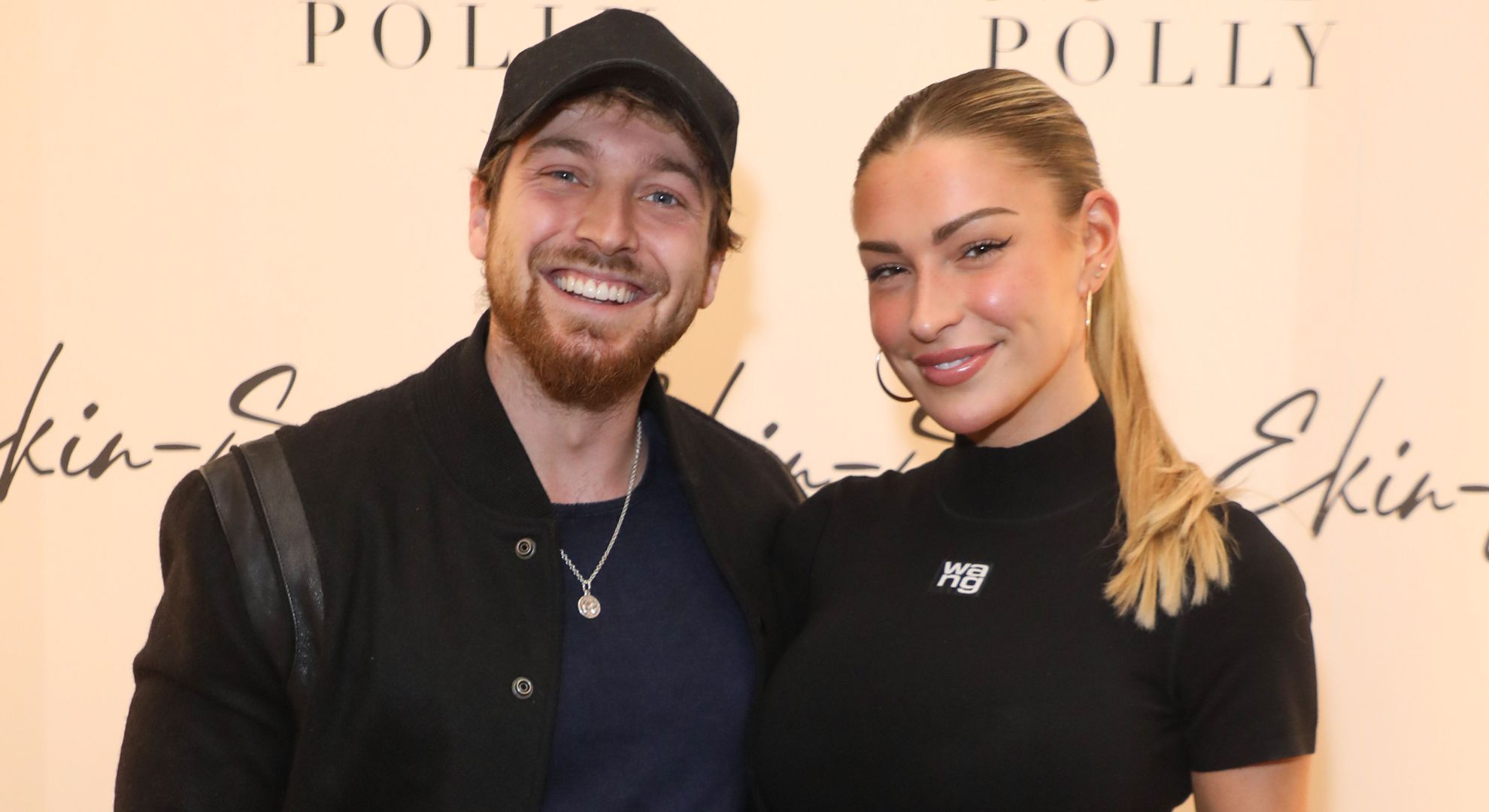 Sam Thompson smiling beside Zara McDermott