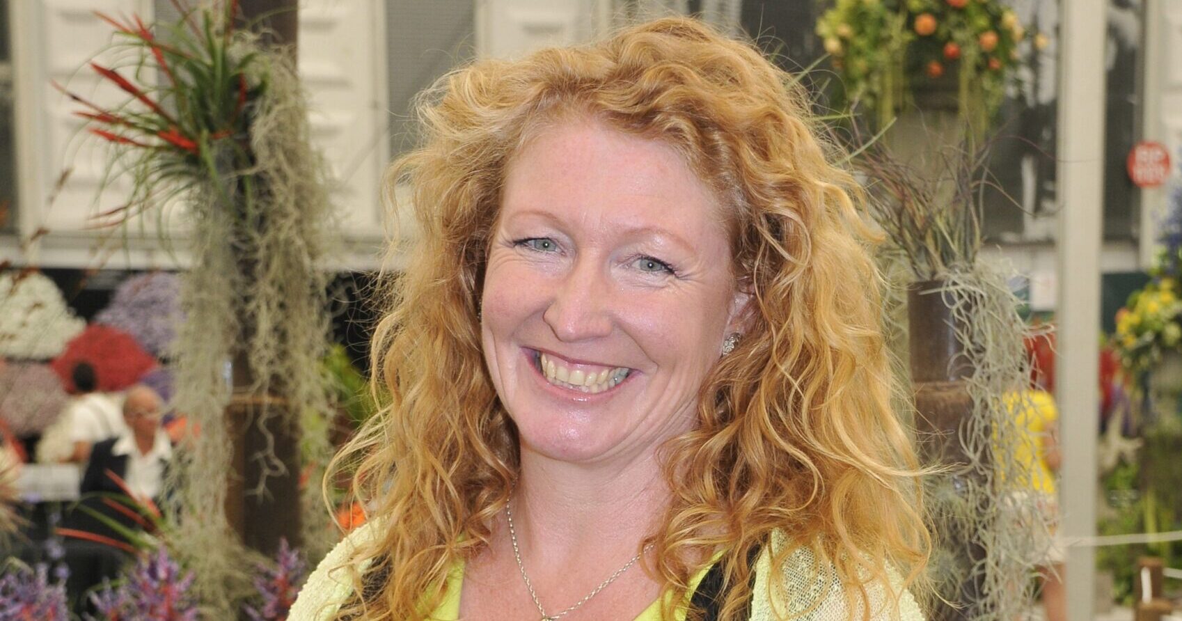 Charlie Dimmock in a yellow shirt and black top