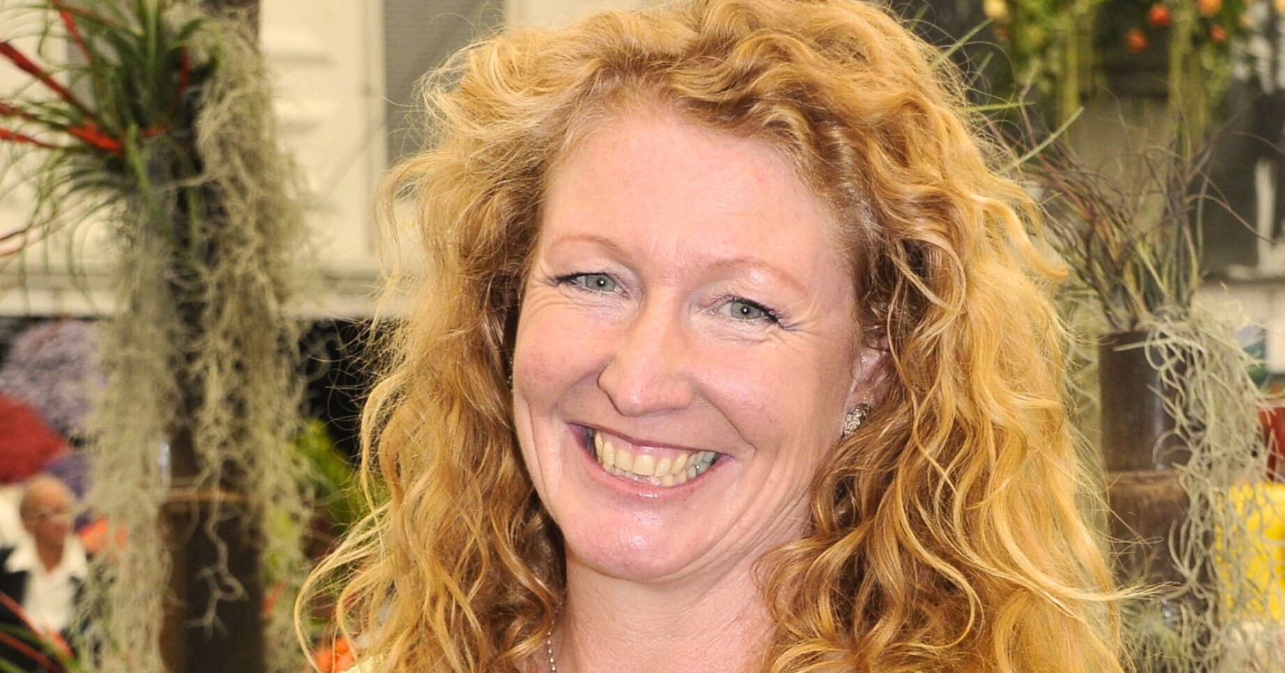Charlie Dimmock in a yellow shirt and black top