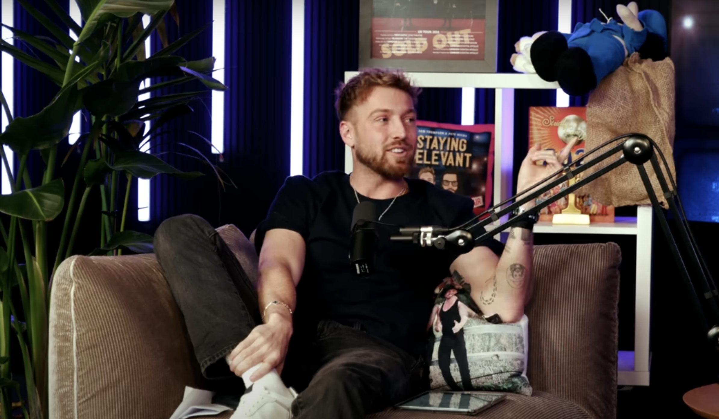 Sam Thompson in black top on Staying Relevant sofa