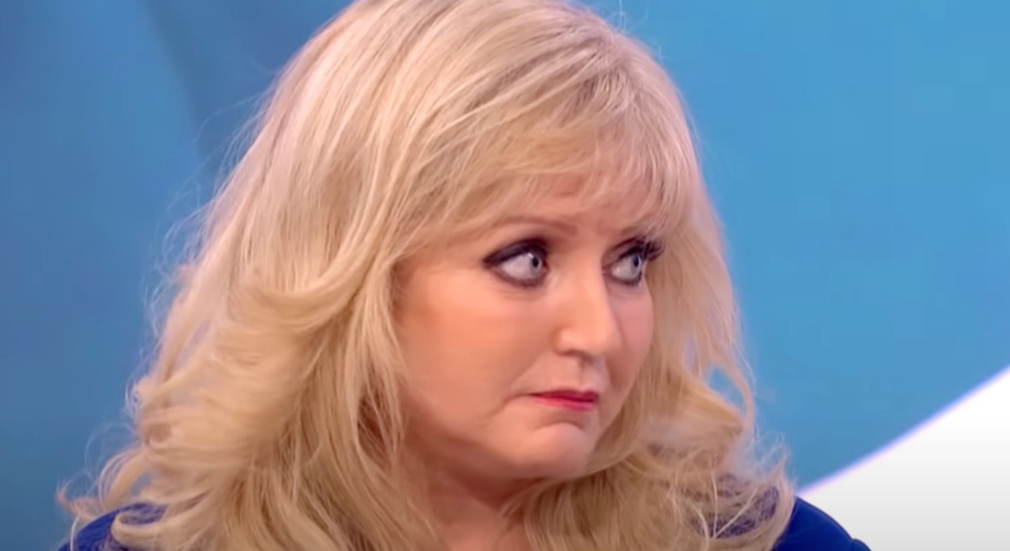 Linda Nolan frowns as she speaks to sister Coleen
