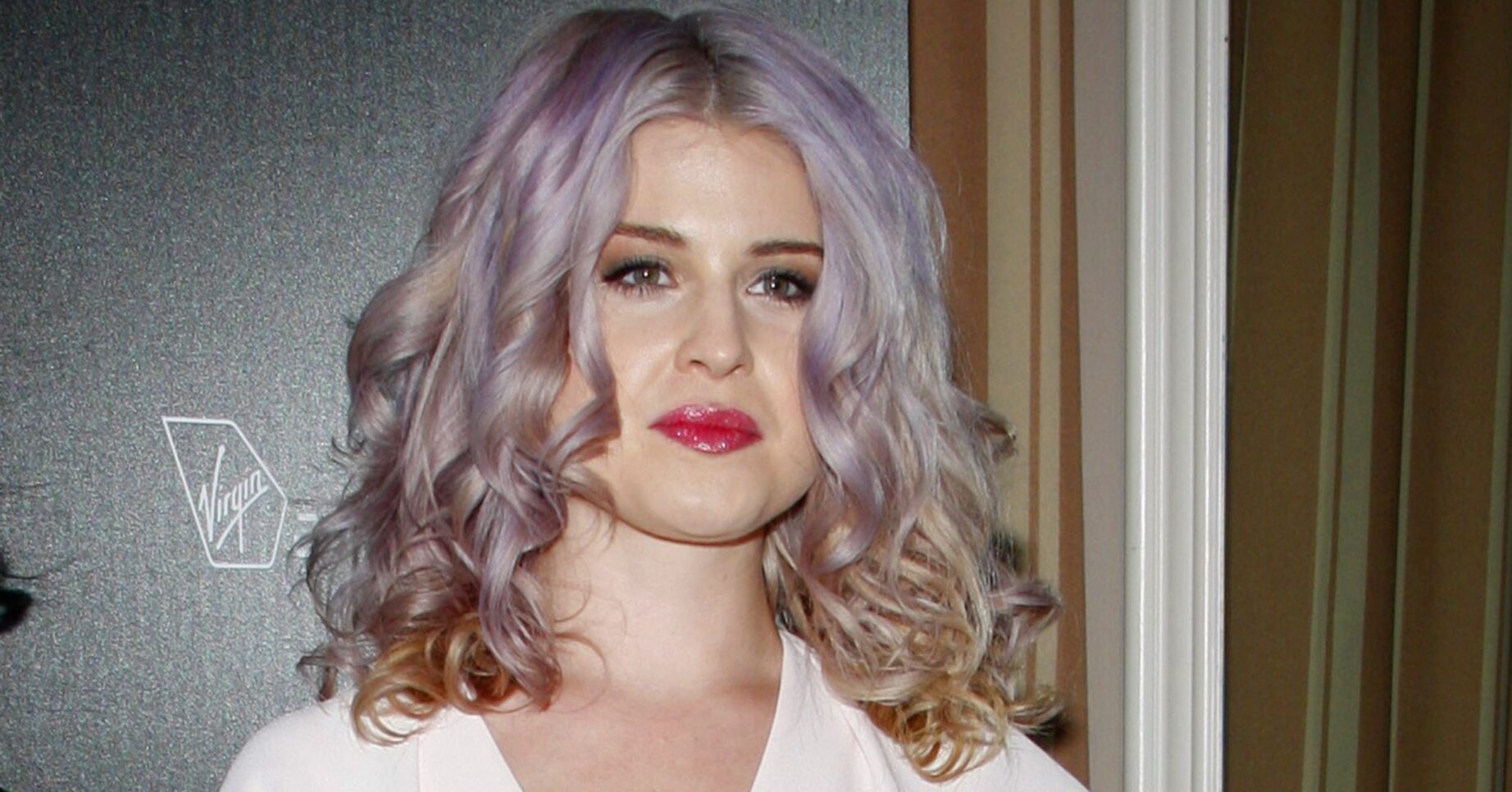 Kelly Osbourne smiling for cameras