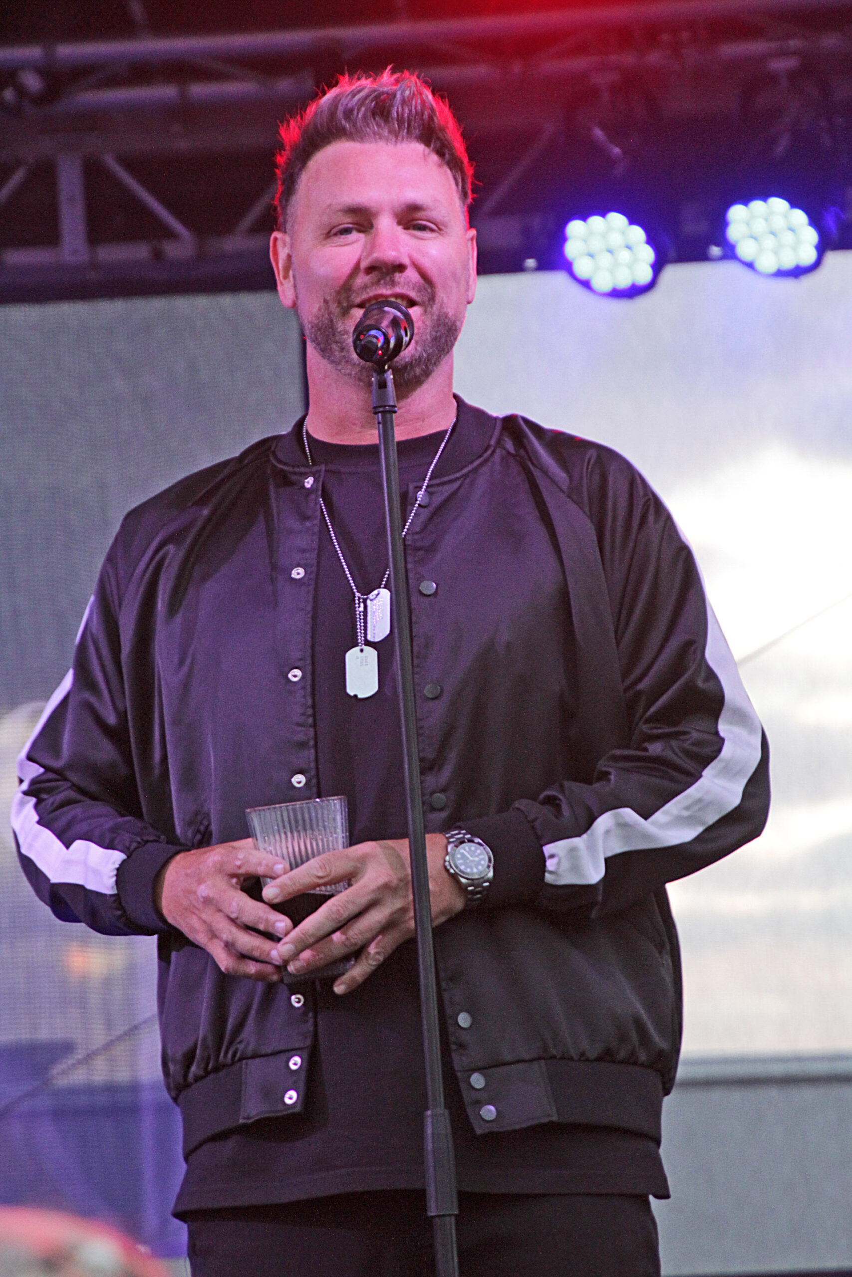 Brian McFadden on the stage speaking into the mic