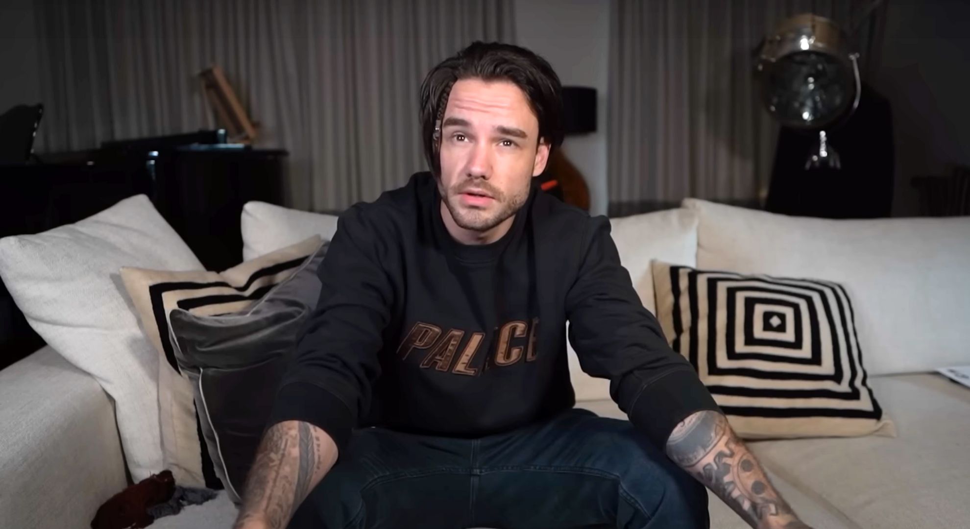 Liam Payne in a black hoody recording a vlog