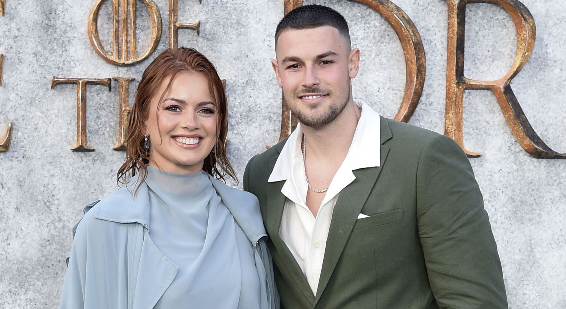 Tasha Ghouri and Andrew Le Page smiling on a red carpet 