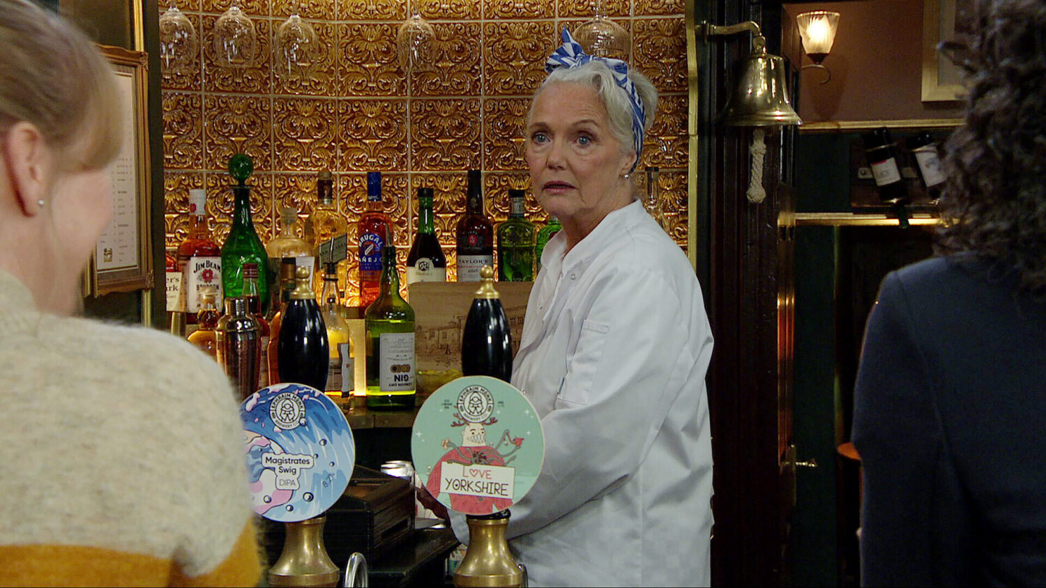 Mary starting at Suzy and Vanessa in the Woolpack