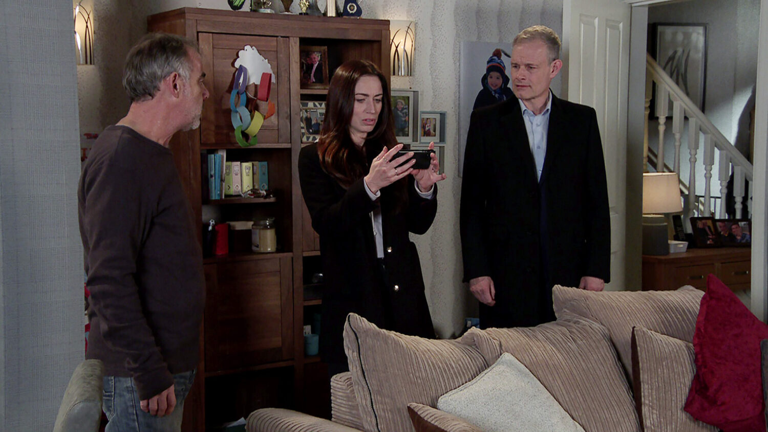 Shona, Nick and Kevin looking at phone