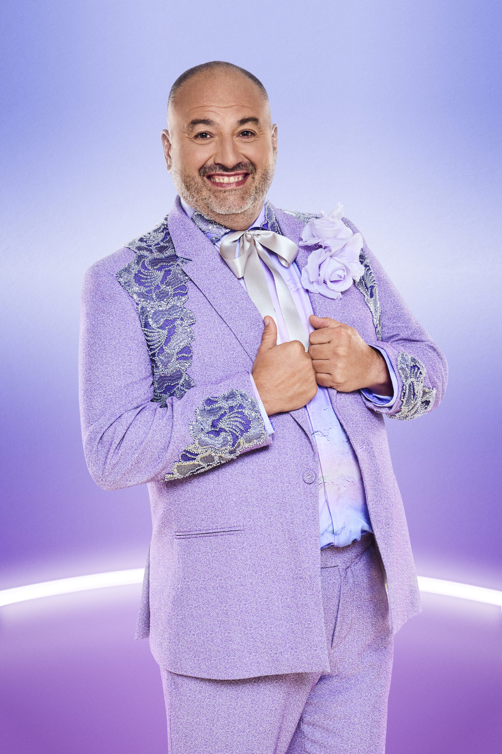 Wynne Evans smiling in a purple suit in a Strictly promo pic