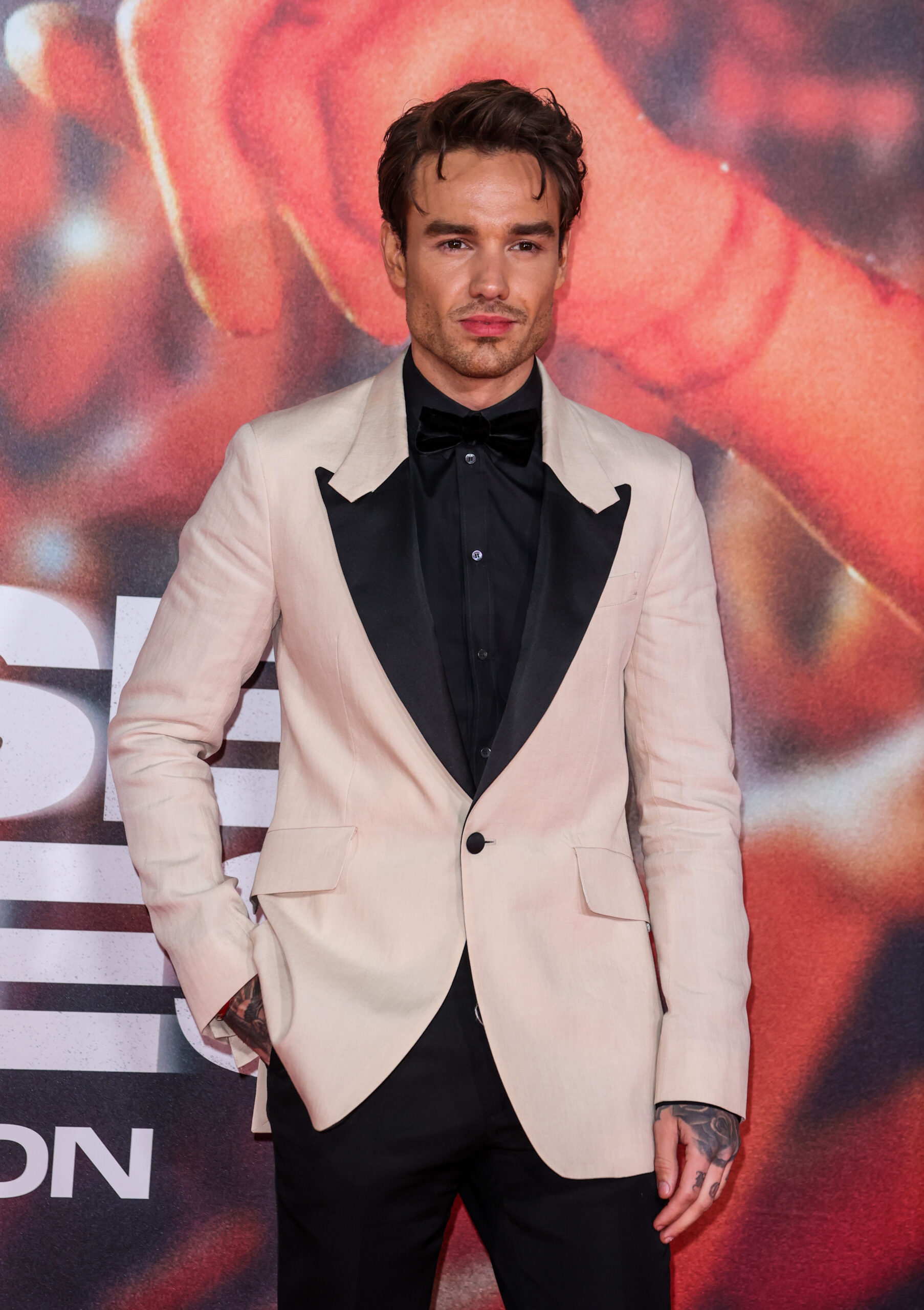 Liam Payne wears a cream and black suit on the red carpet