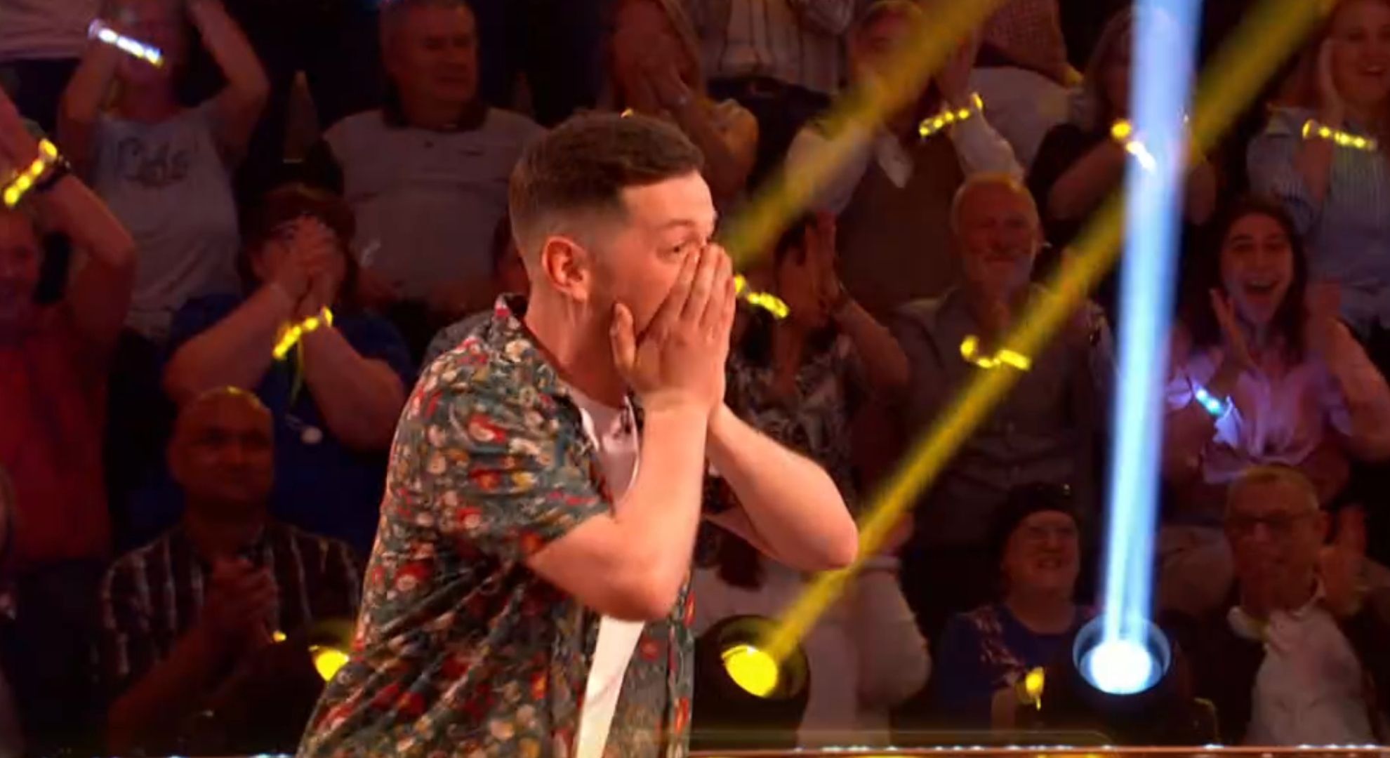Charlie covering his mouth in surprise after winning on Beat the Chasers
