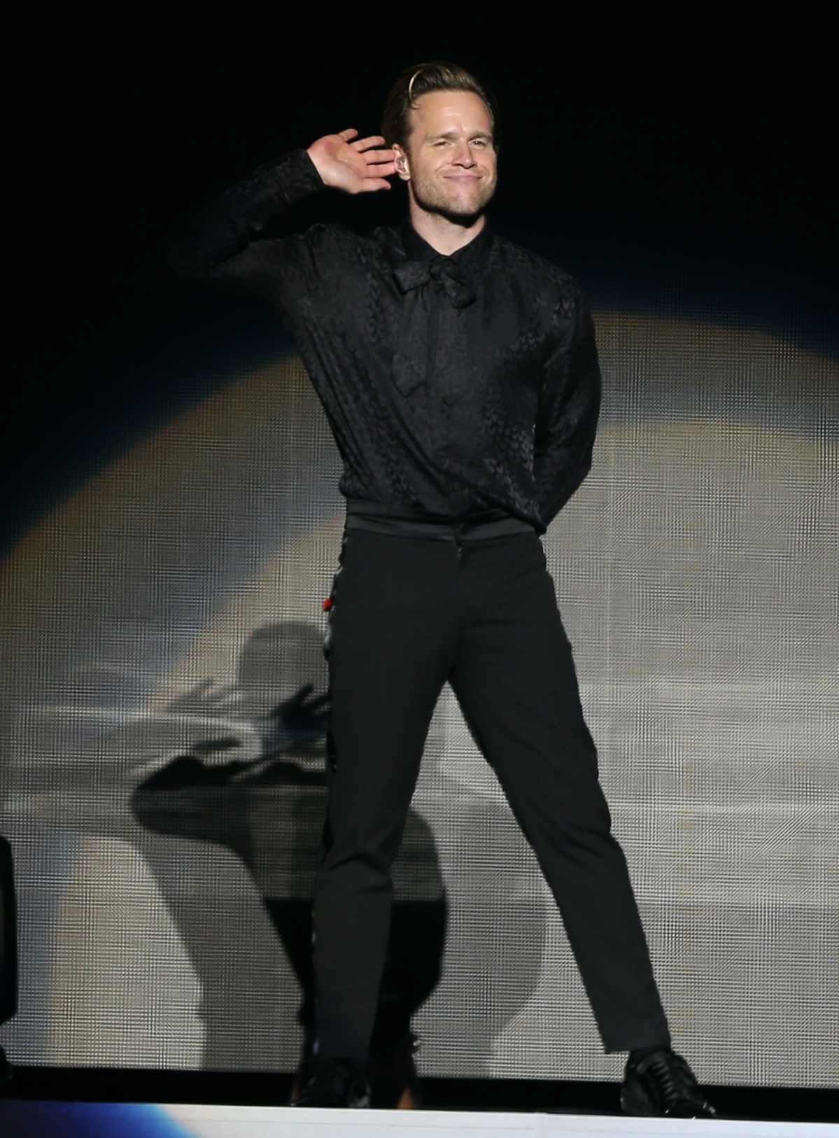 Olly Murs performing on stage 