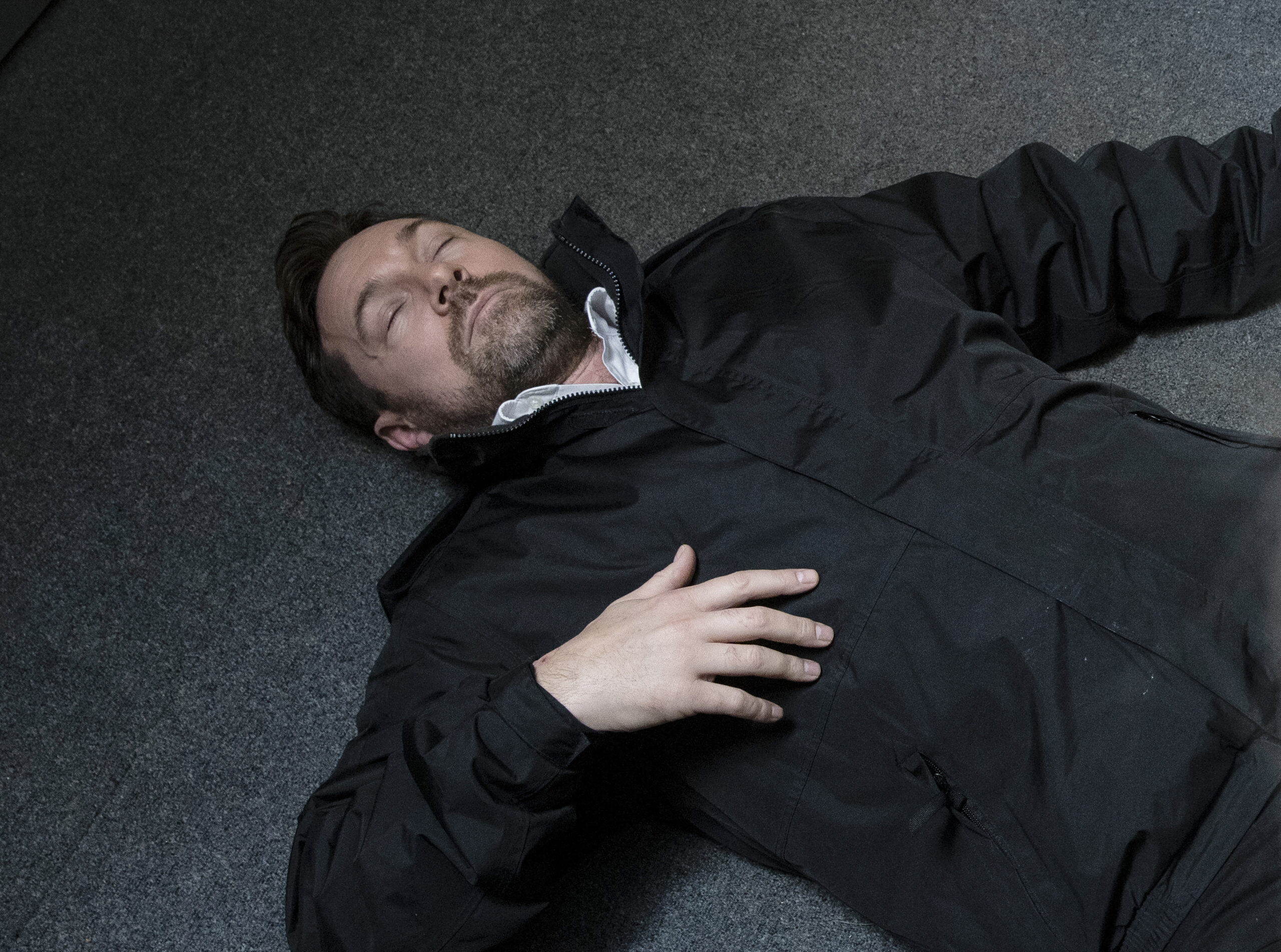 Rob lying unconscious on the floor