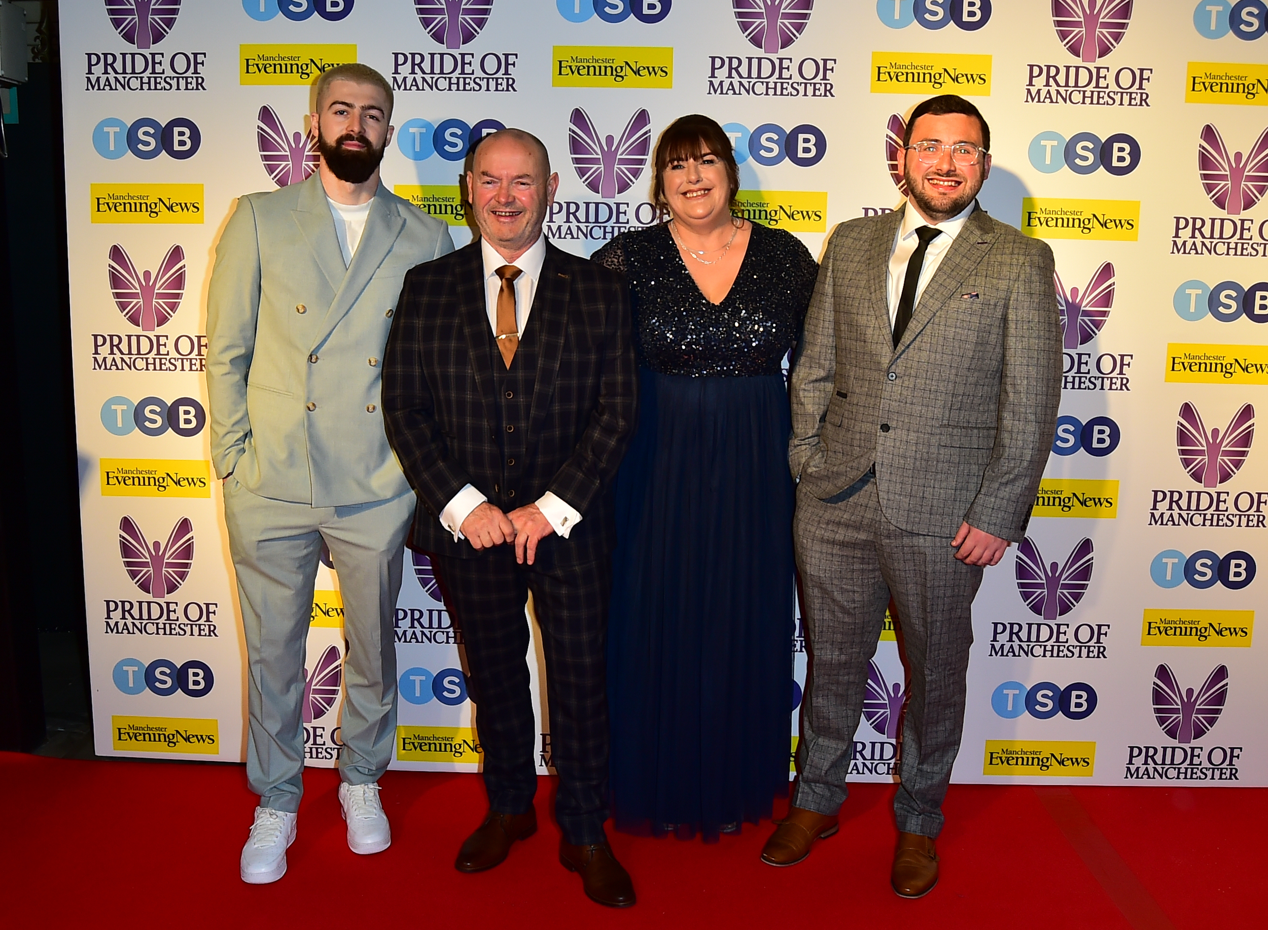 The Malone family members posing on red carpet