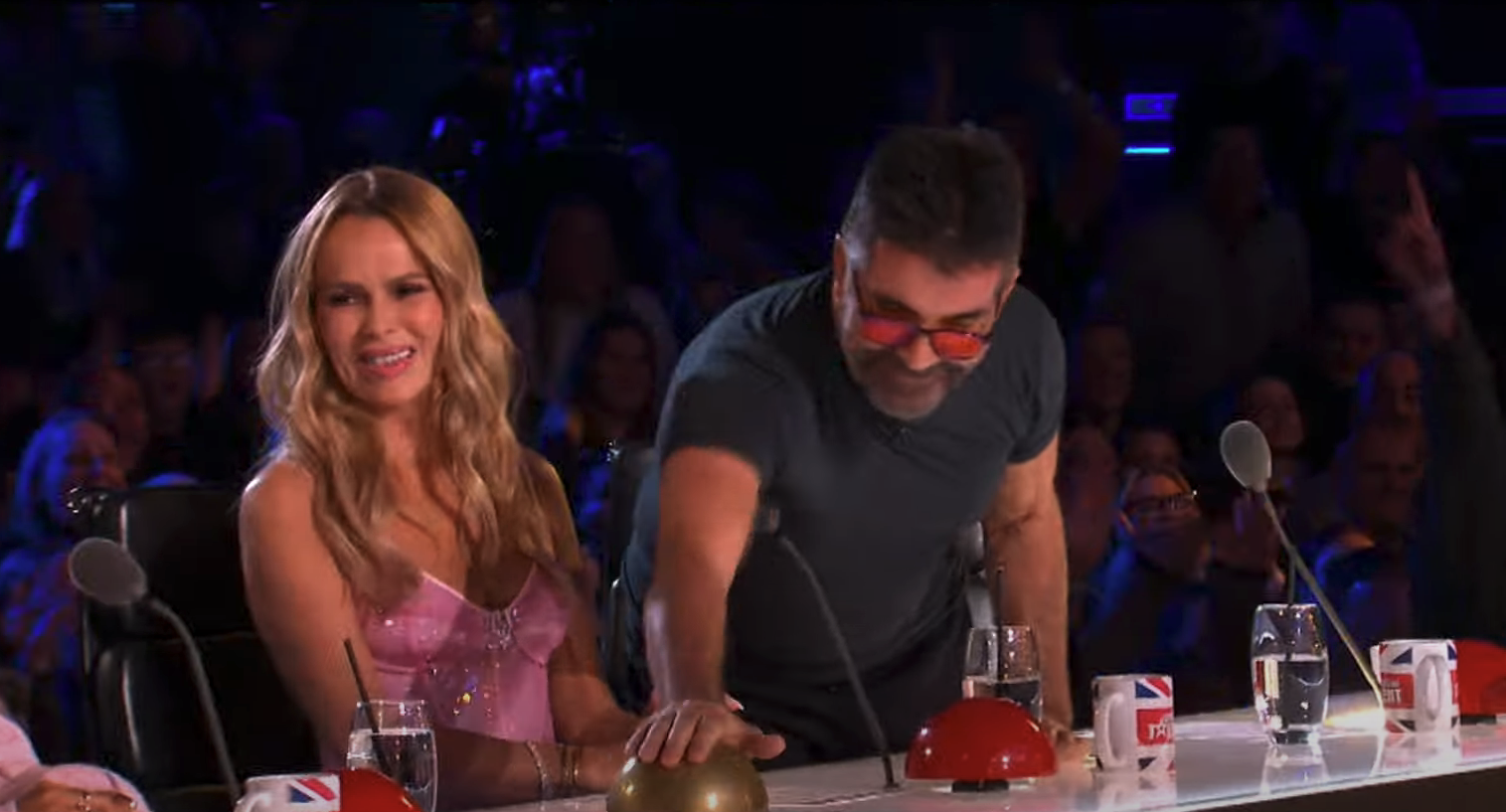 Amanda Holden smiles as Simon Cowell presses his golden buzzer on BGT
