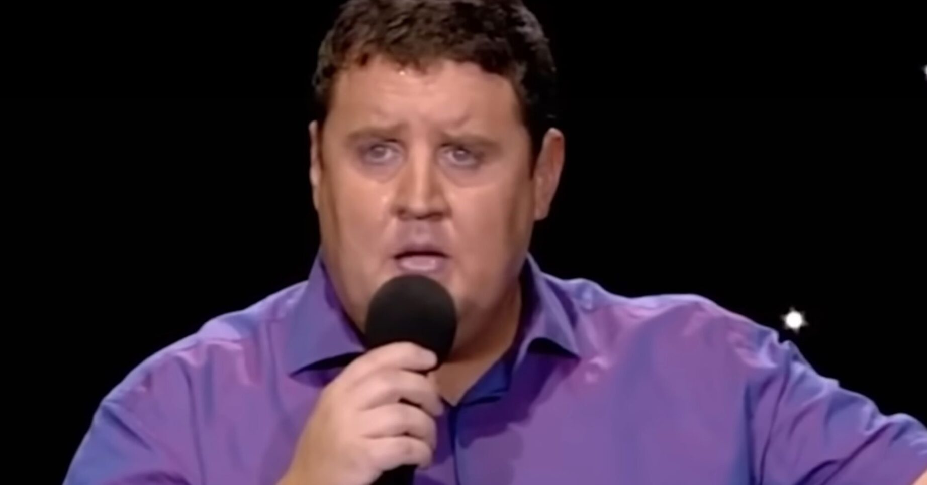 Peter Kay looking front while talking on mic