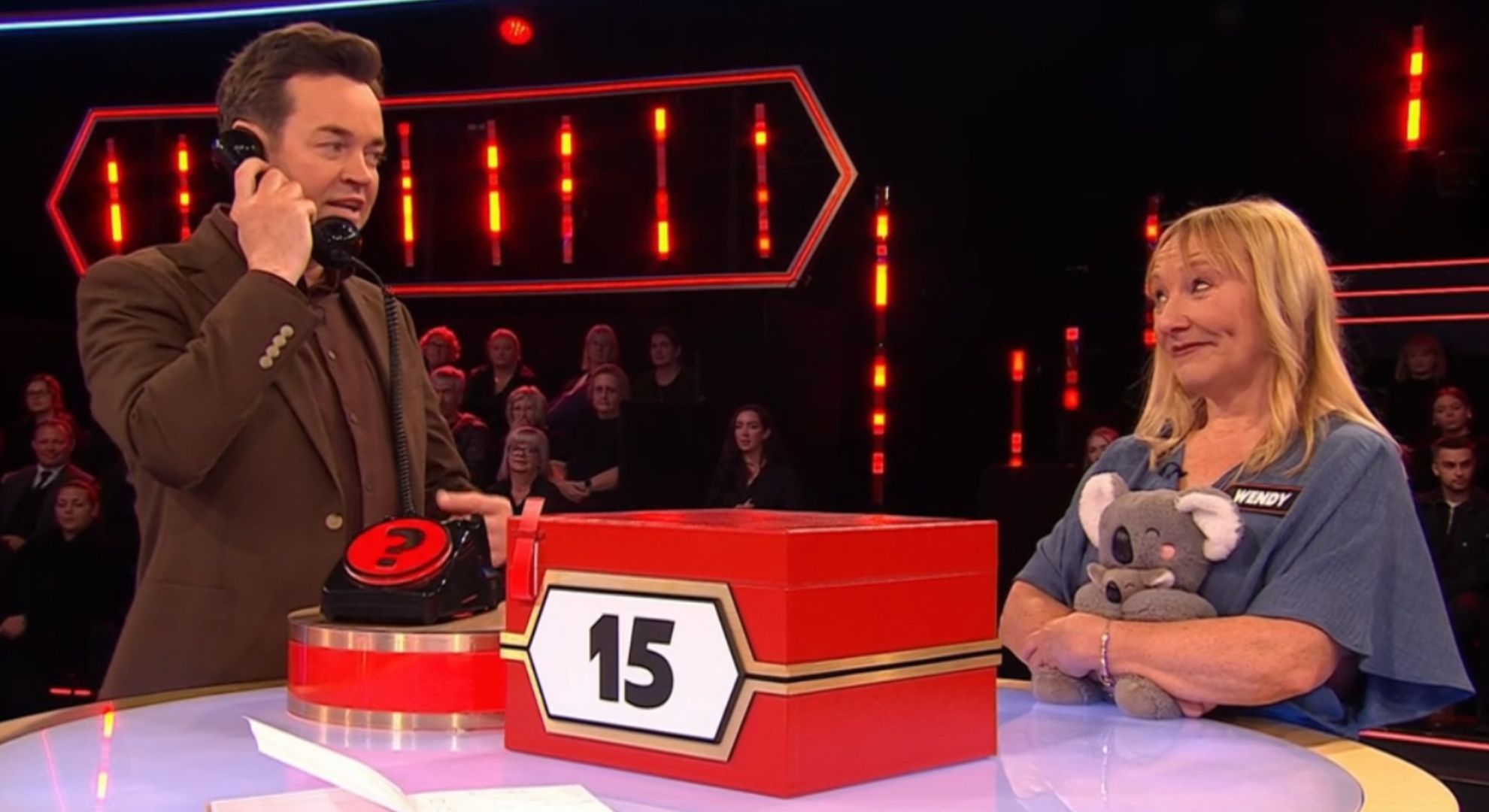 Stephen Mulhern on the phone while speaking to Wendy on Deal Or No Deal 