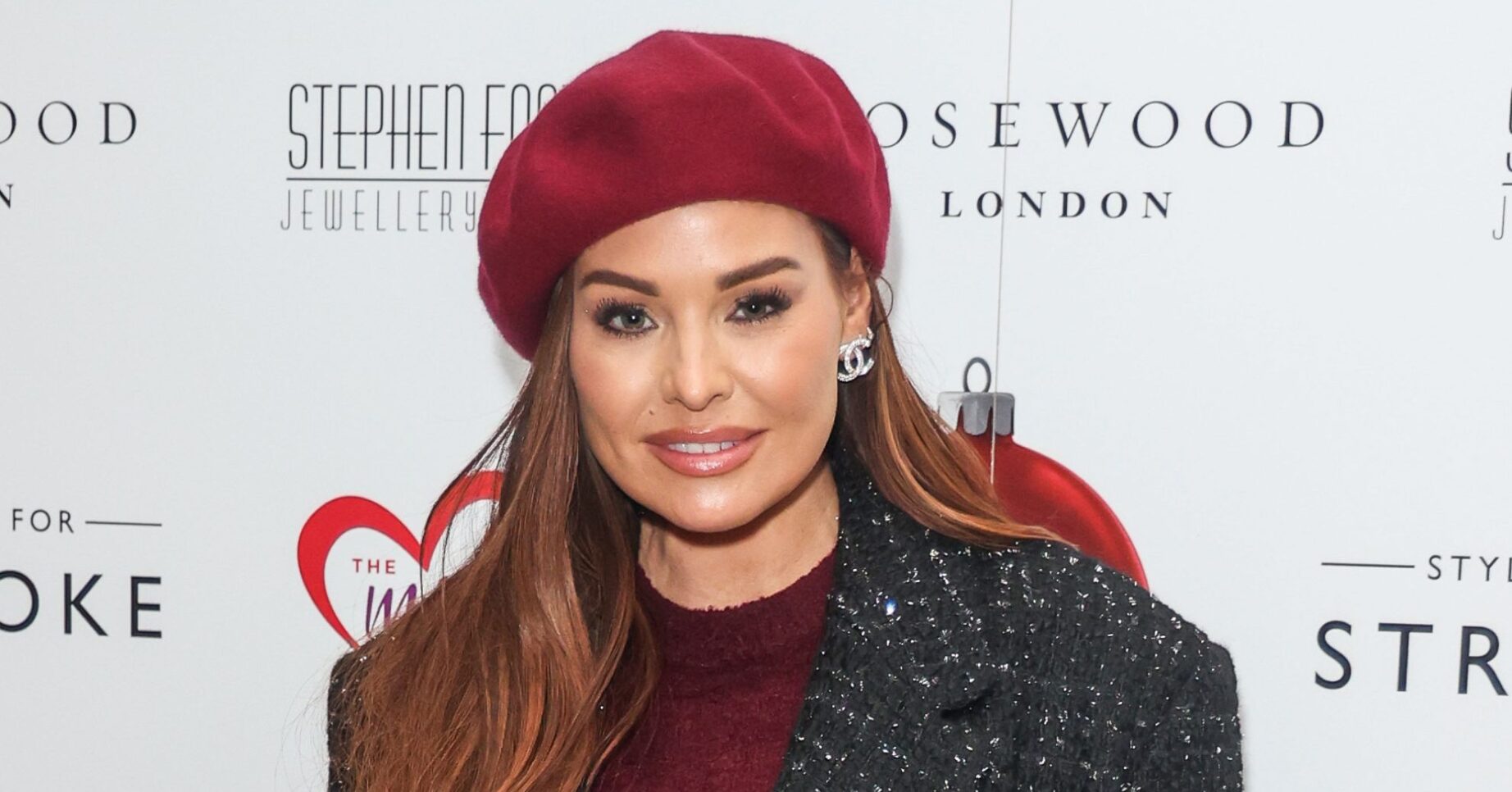 Jess Wright wearing red hat at event looking at camera