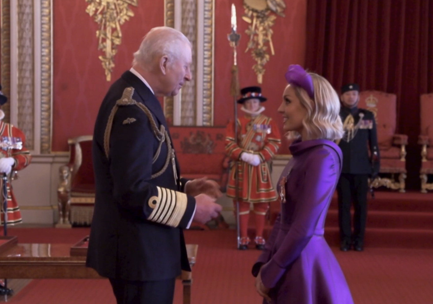 King Charles giving Amy Dowden her MBE at Buckingham Palace