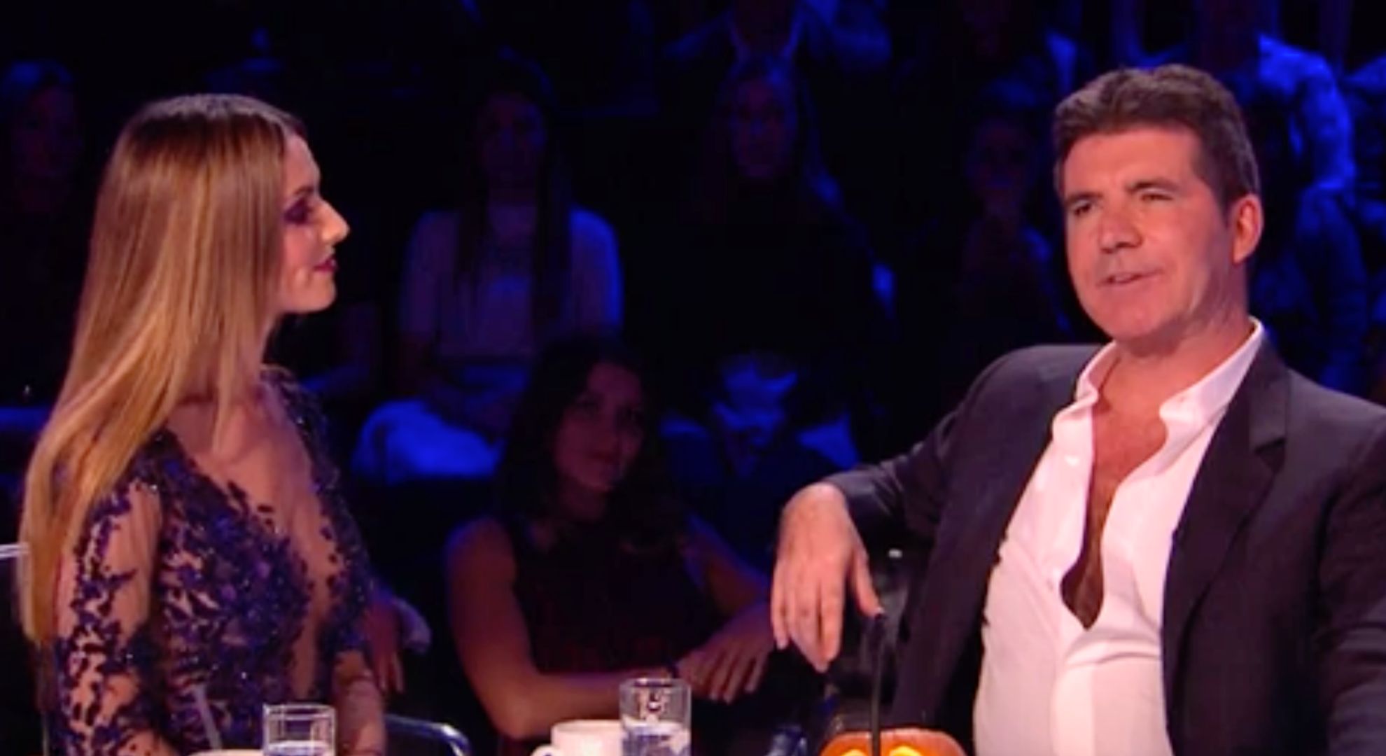 Cheryl listens to Simon Cowell