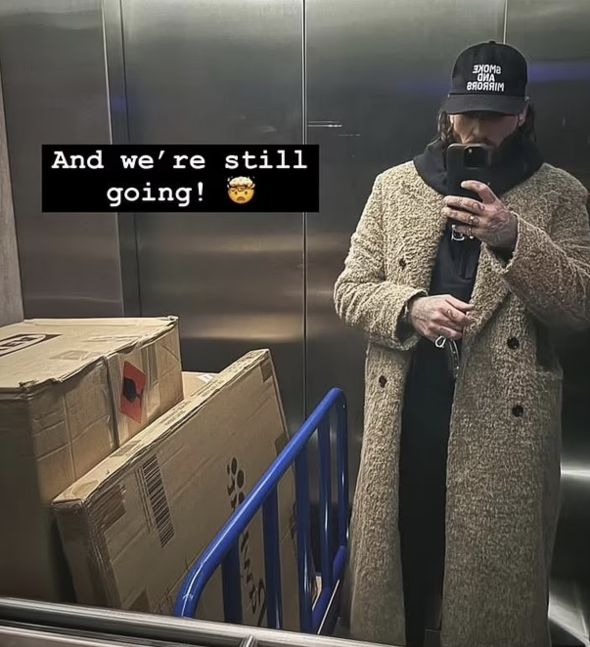 Pete Wicks sharing an elevator mirror selfie besides a stack of boxes