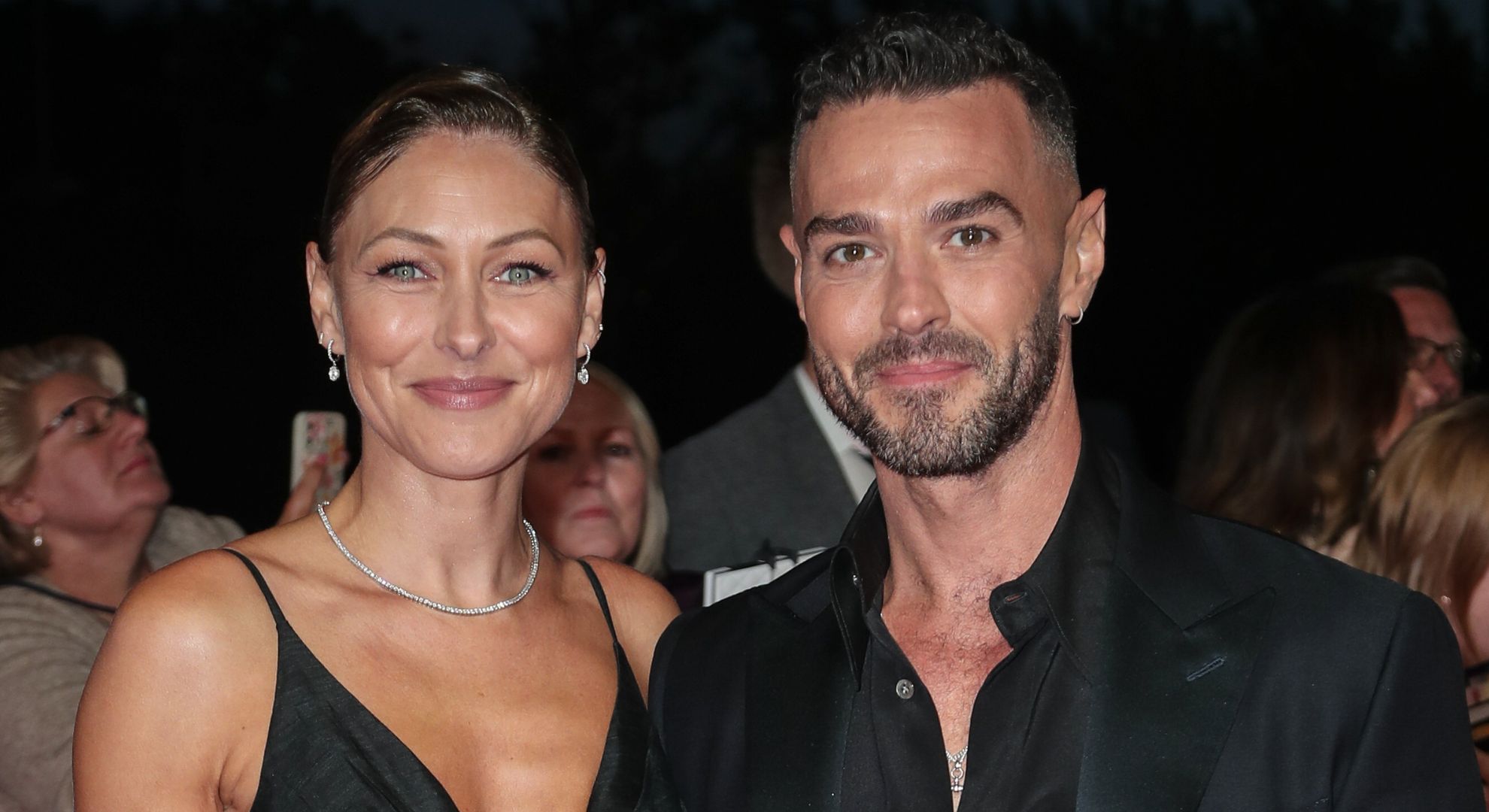 Emma and Matt Willis smiling and wearing black