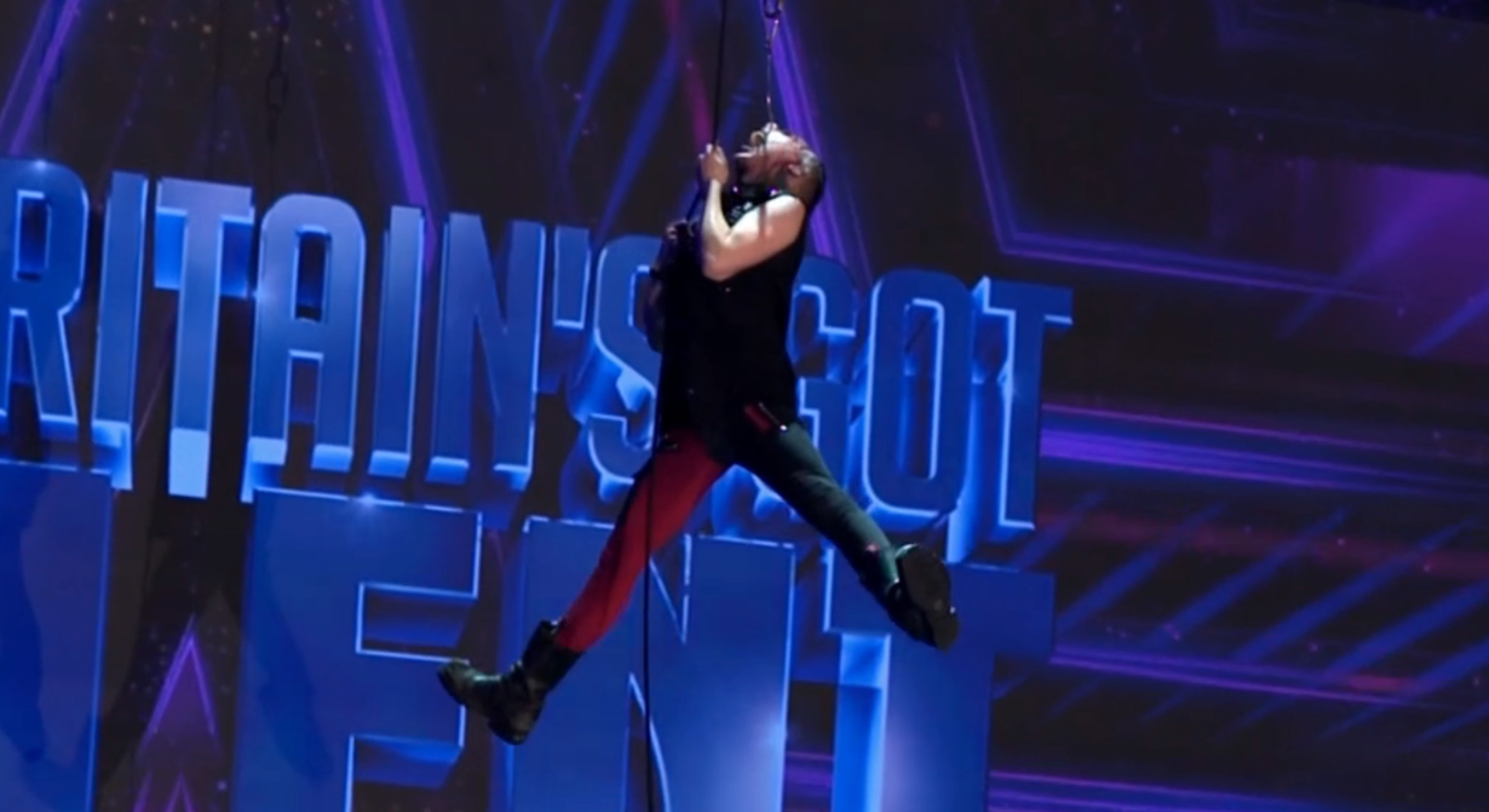 Auzy Blood hanging from the ceiling on BGT with legs wide