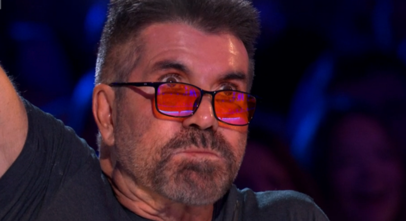 Simon Cowell pulling a sickened face