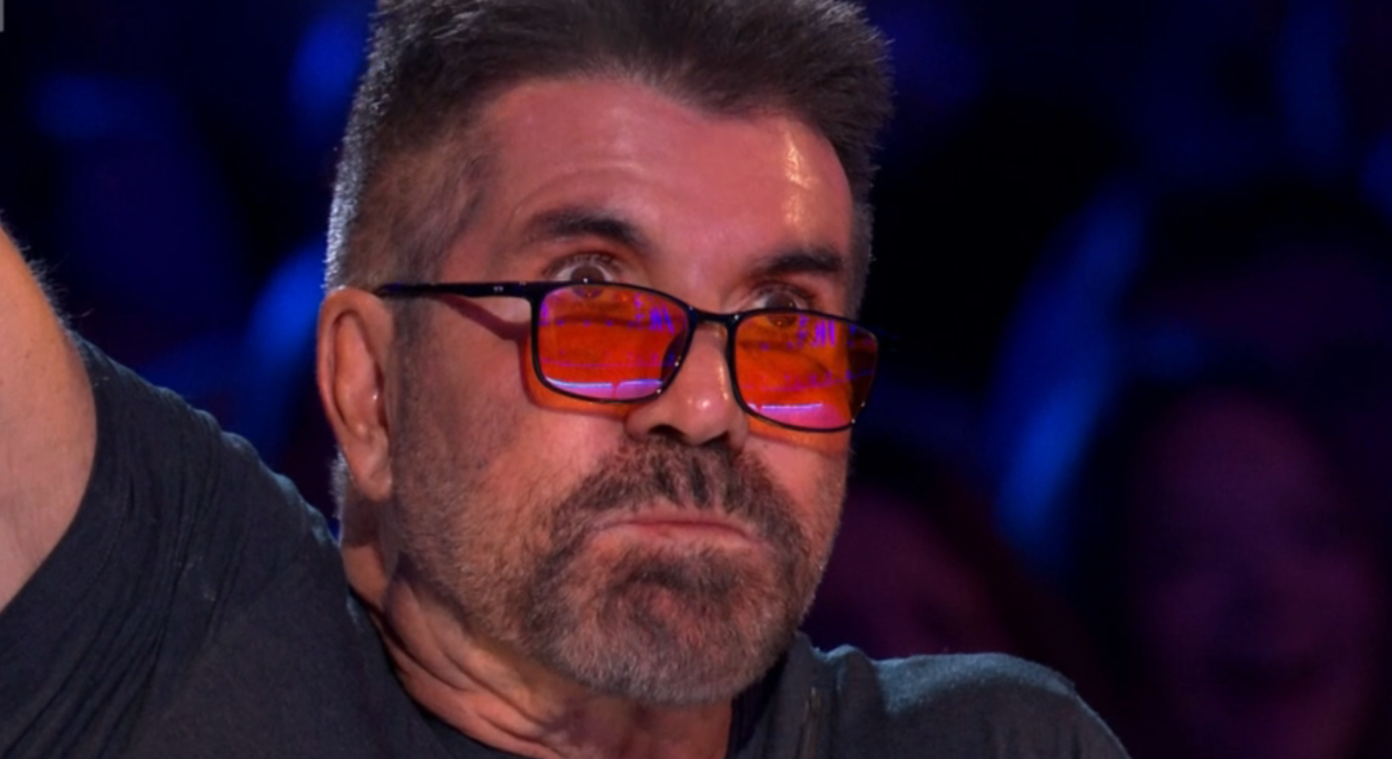 Simon Cowell pulling a sickened face