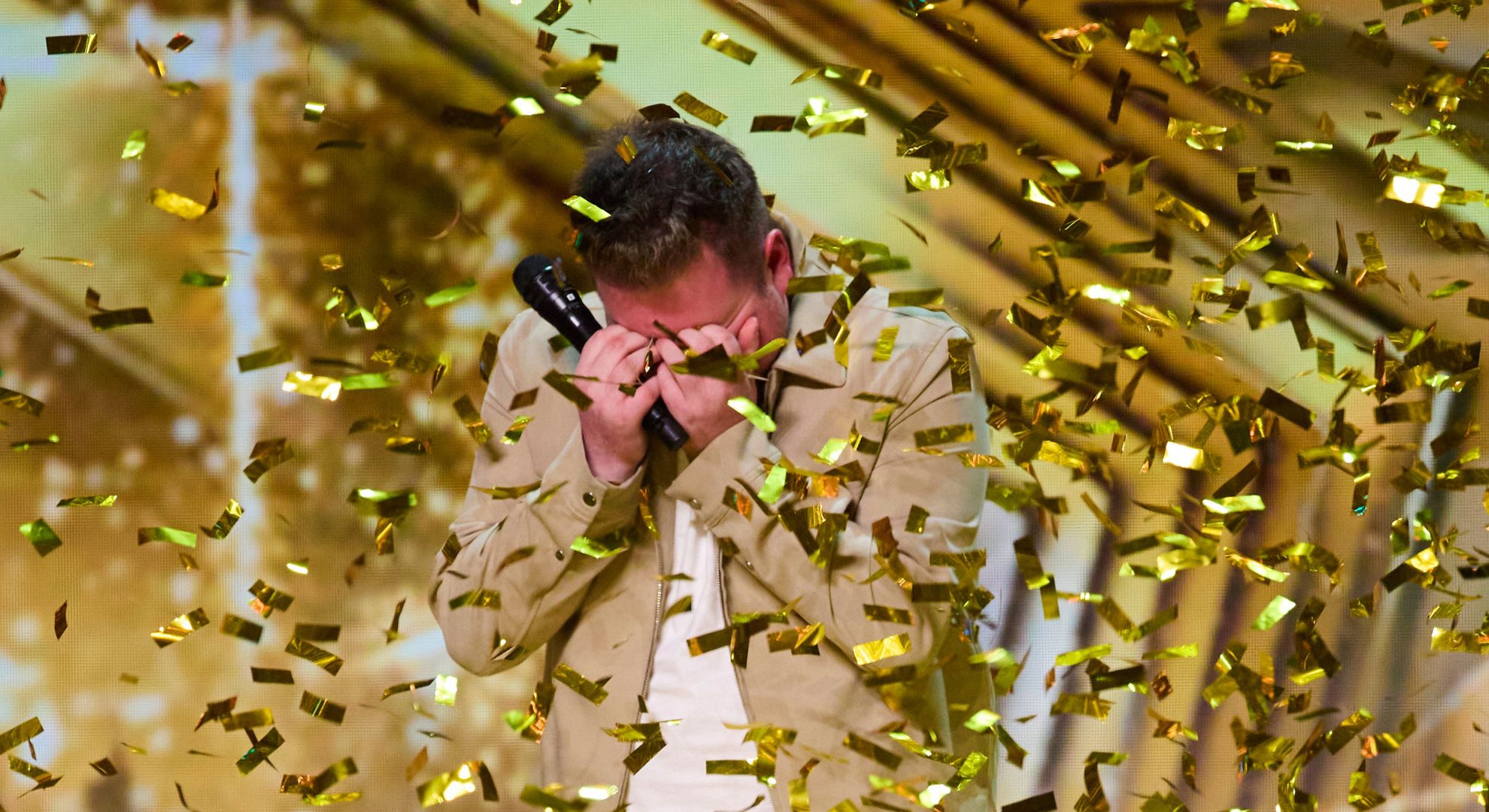 Vinnie McKee sobbing as gold confetti falls around him on BGT