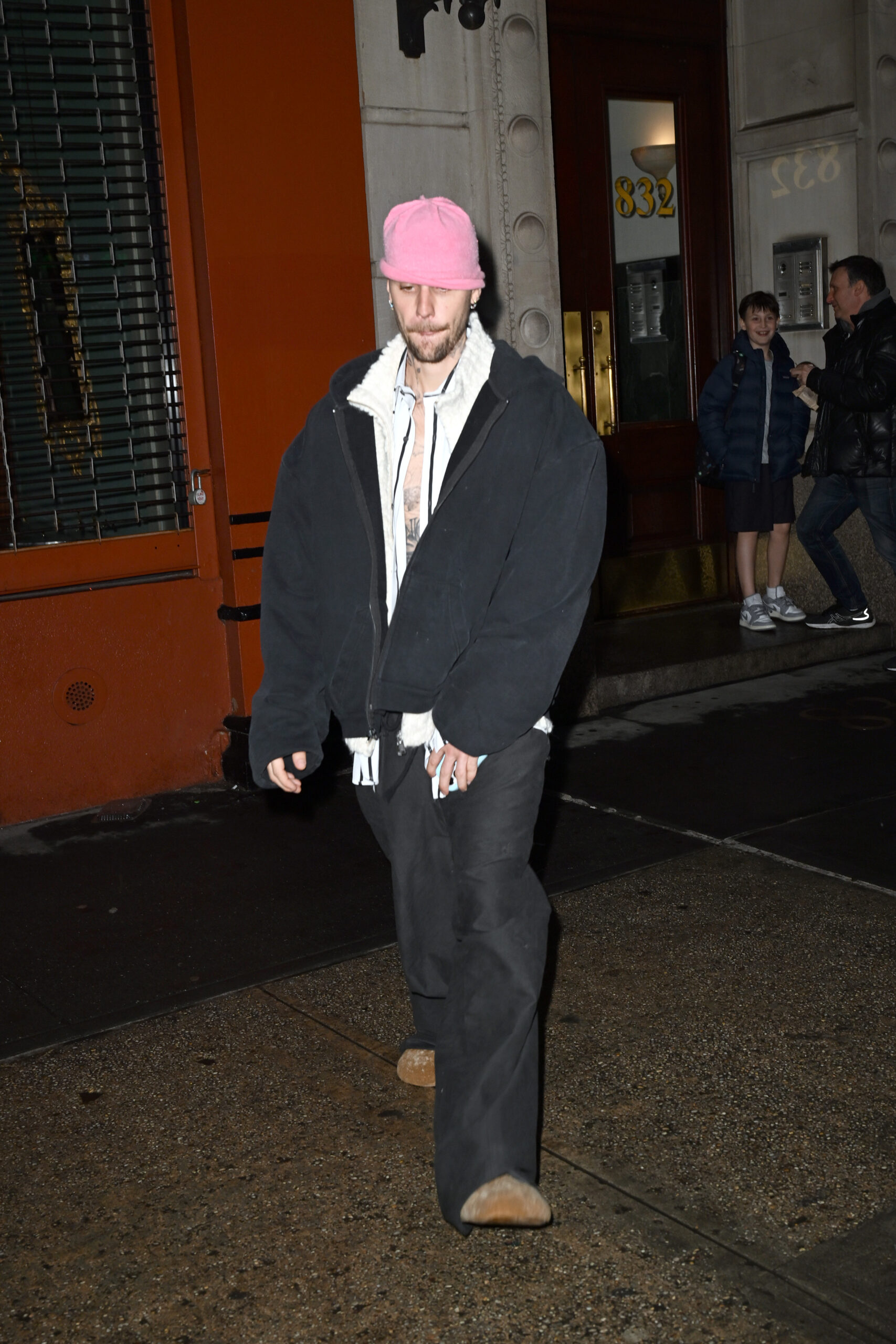 Justin Bieber in black oversized suit and pink cap